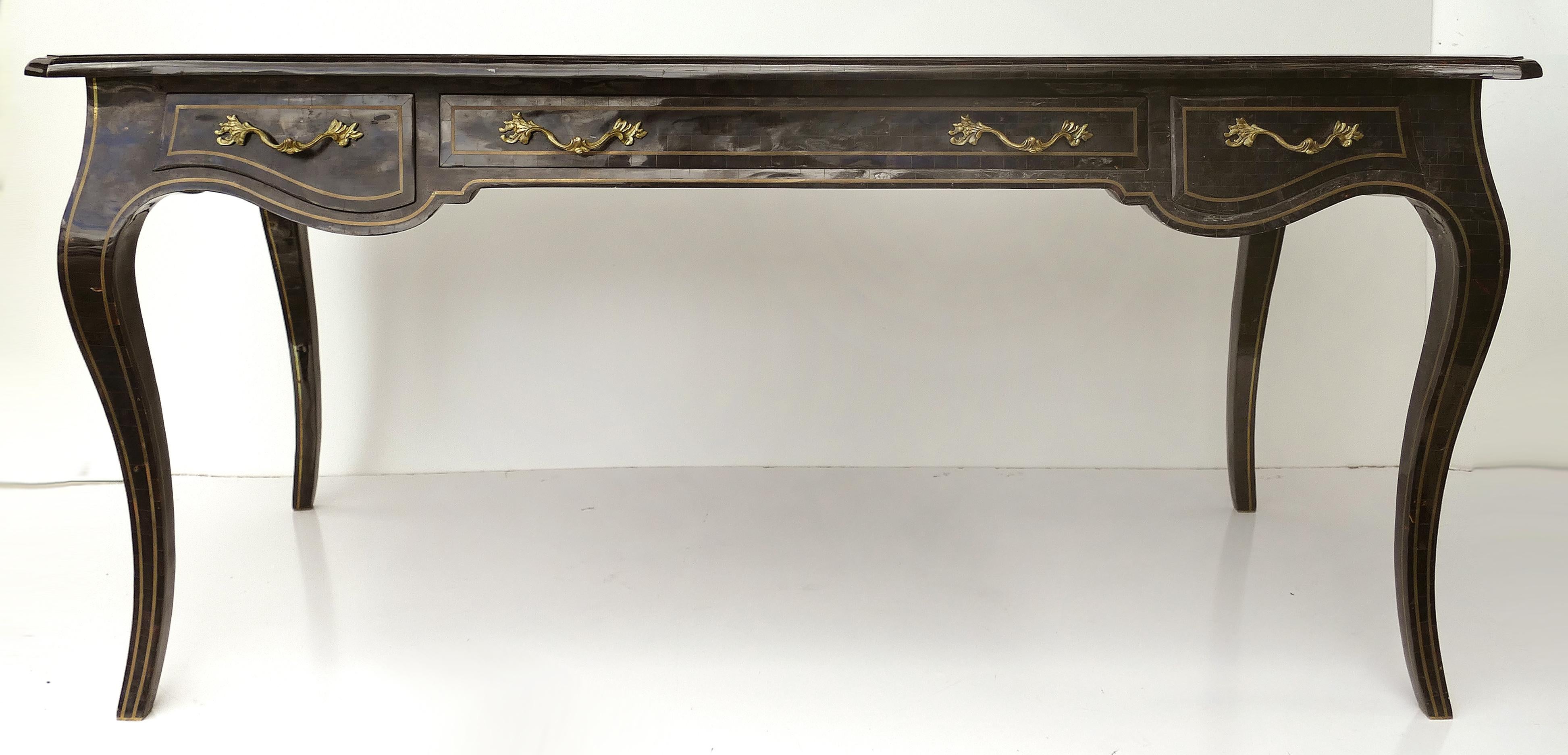 Maitland Smith tessellated horn writing table desk with brass trim

Offered for sale is an elegant 1980s Maitland Smith writing table desk in tessellated Horn and brass. This neoclassically inspired desk is quite large and could be used as a