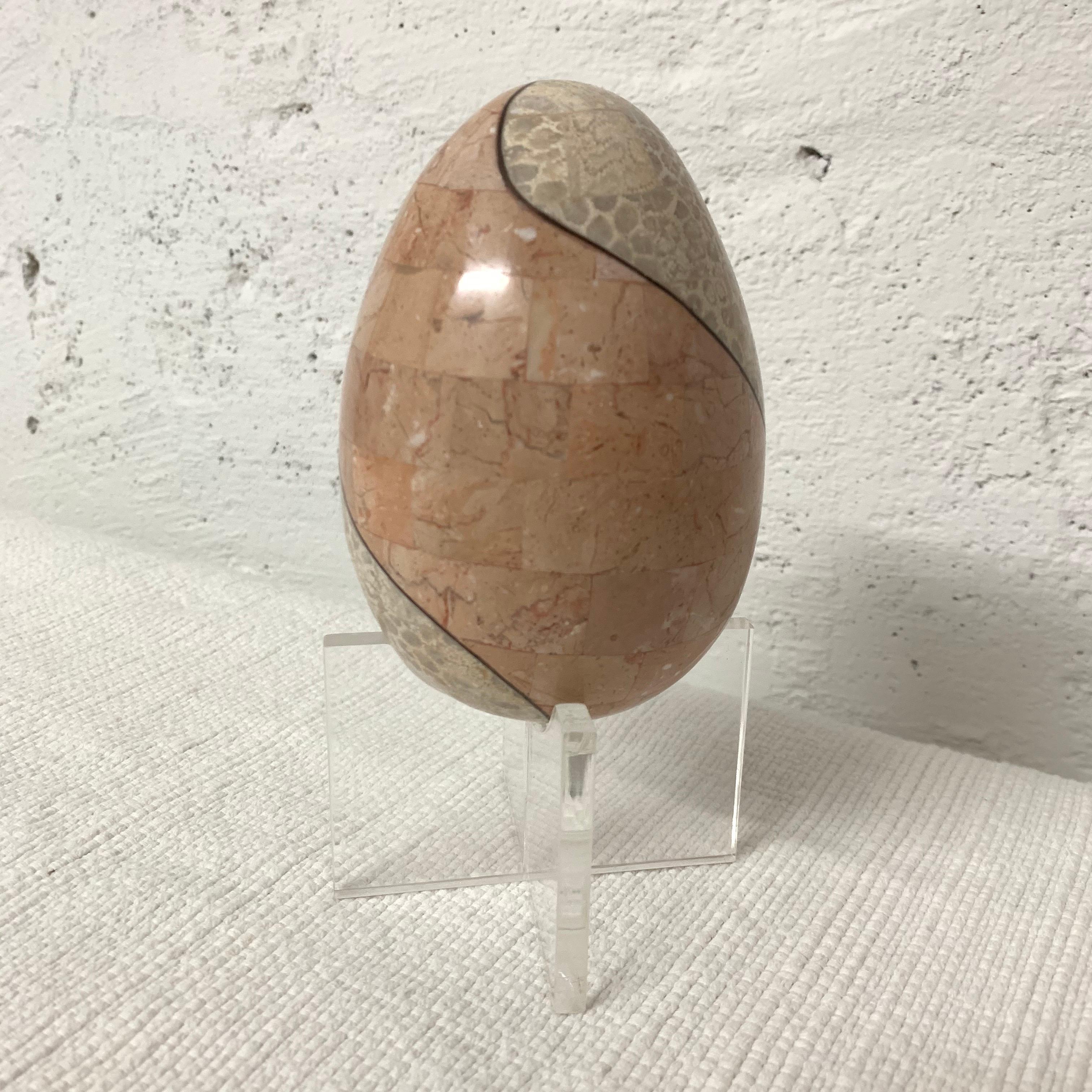 Unique egg on a Lucite stand rendered in bicolored tessellated marble with a bronze inlay by Maitland Smith.