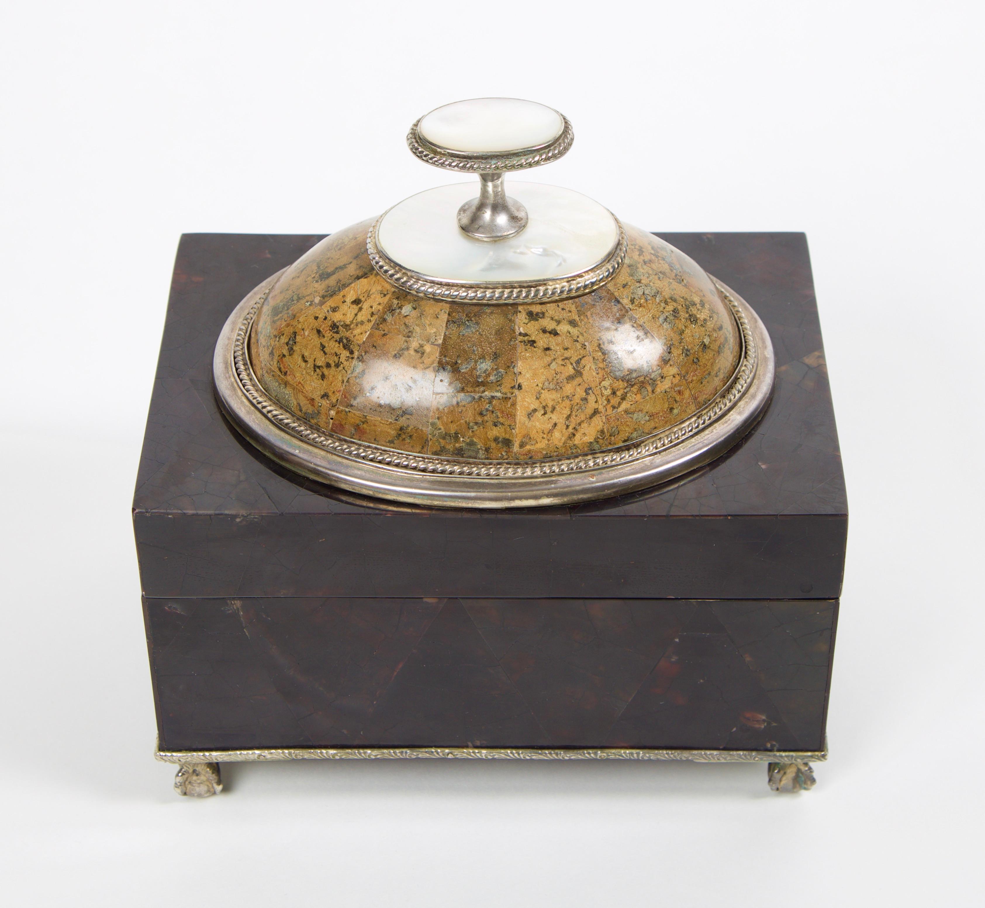 Maitland Smith tessellated stone box with a mother of pearl finial handle. The interior of the box is lined with a black felt and has a removable lid. The box rests on sterling silver ball and claw feet as well as the entirety of the box is framed