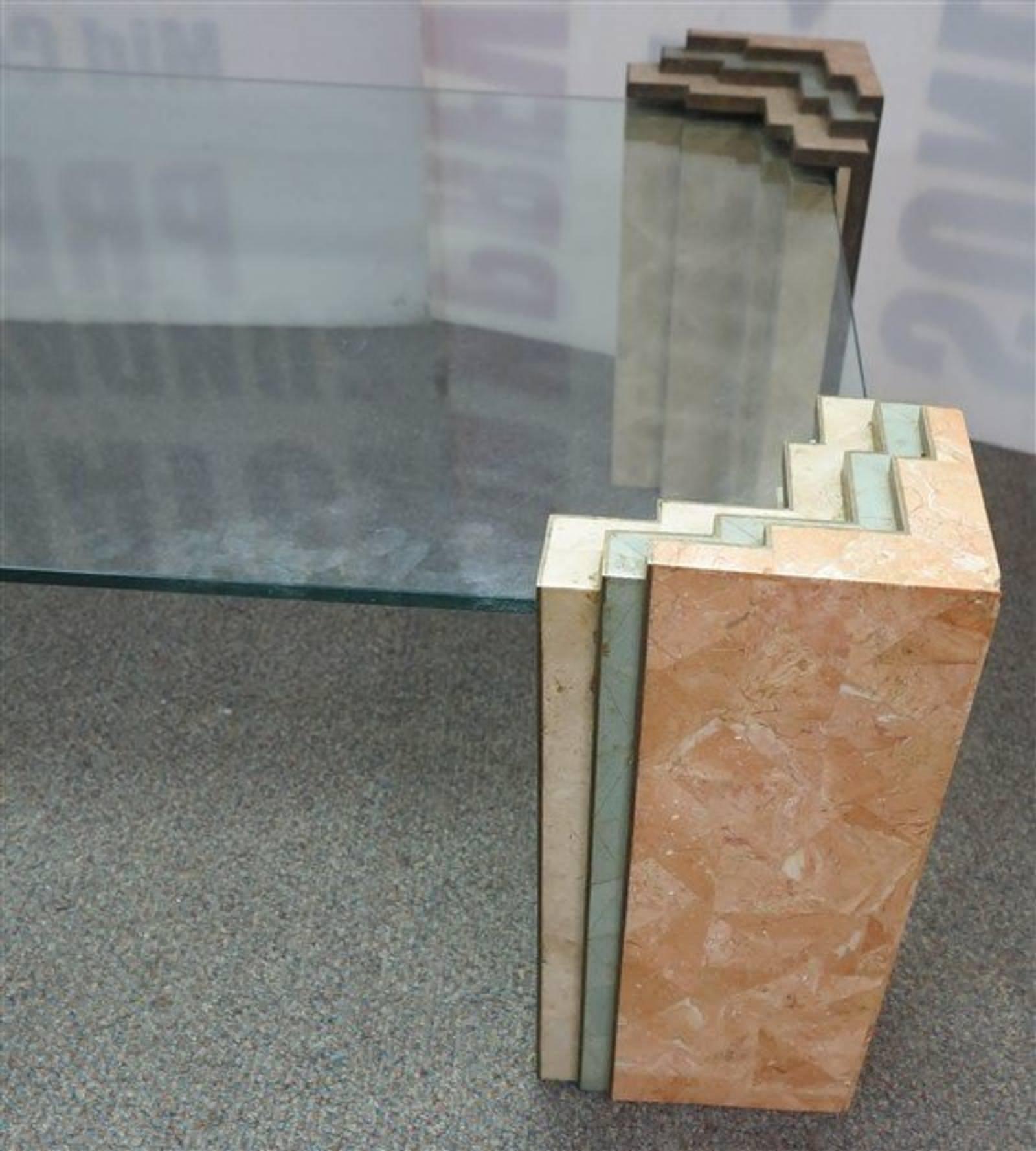 Stunning tessellated glass-top coffee table with rose, teal and cream marble with brass accented corner posts that both support and envelop the glass top. 
