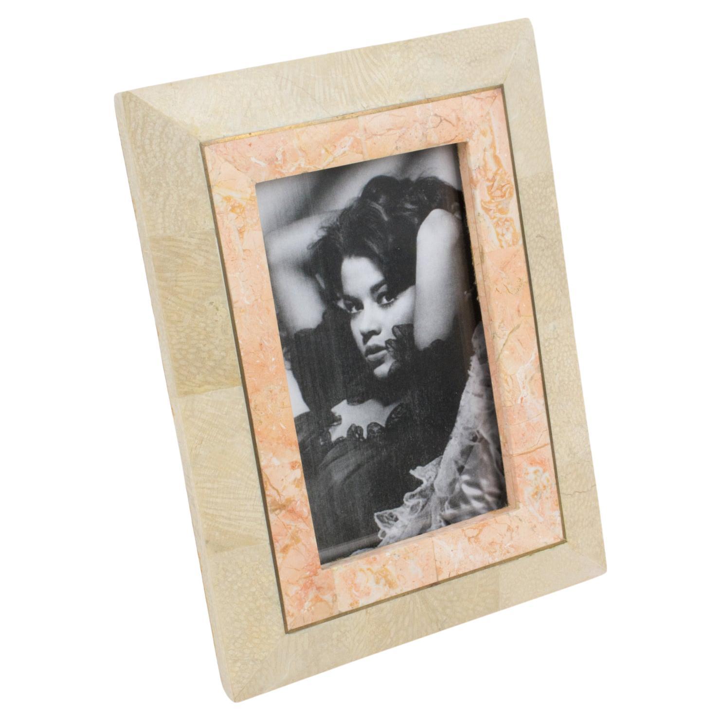 Handsome picture photo frame designed by Maitland-Smith in the 1980s, rendered in tessellated marble, stone, and travertine. Assorted color of light pink salmon and sand beige. The back and easel are in brown velvet. There is no visible maker's