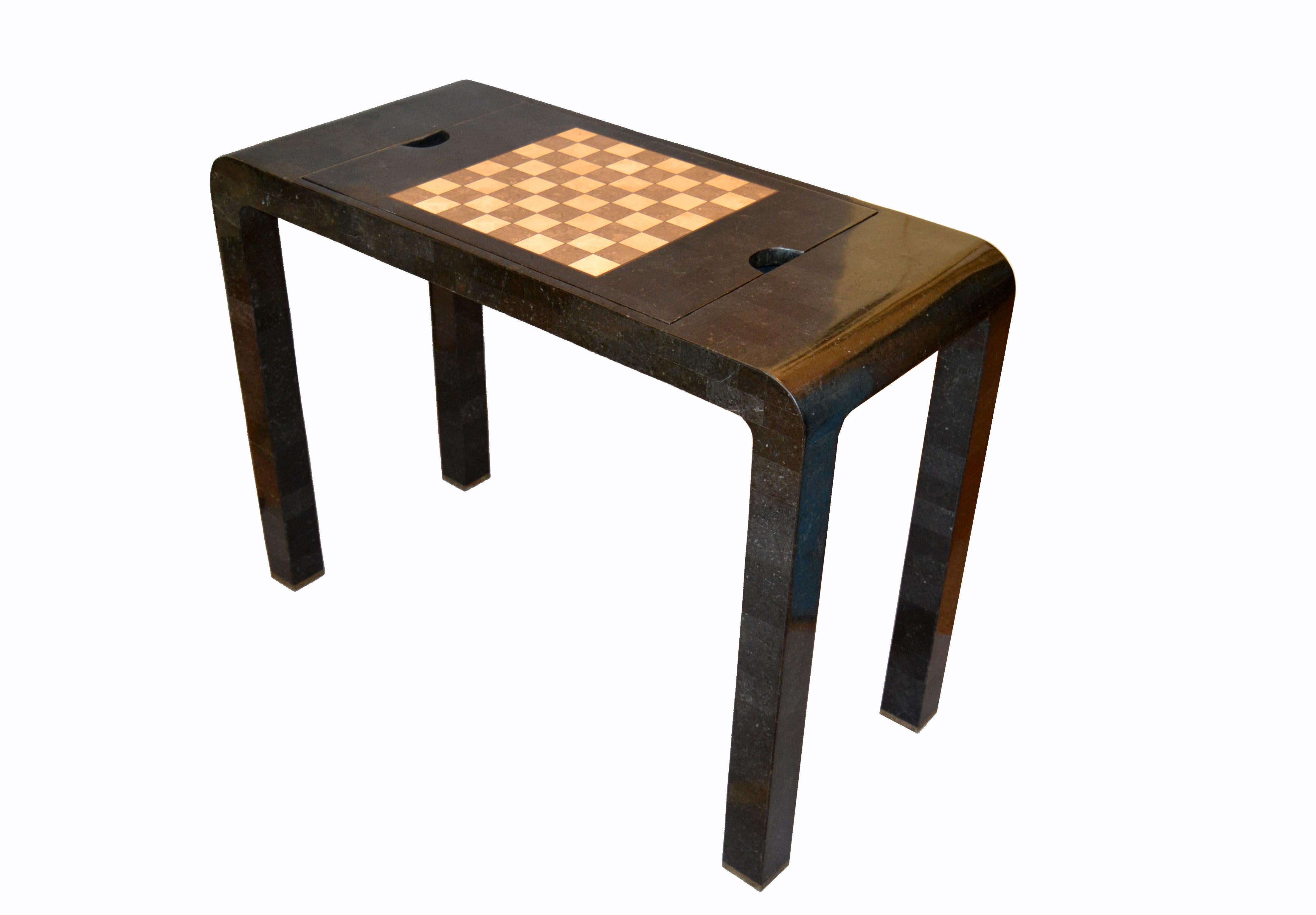 Mid-Century Modern reversable console into a chess or backgammon game table by Maitland Smith.
A dark gray tessellated stone over wood covered table or console. The centre section can be rotated into a chess game or taken off to play