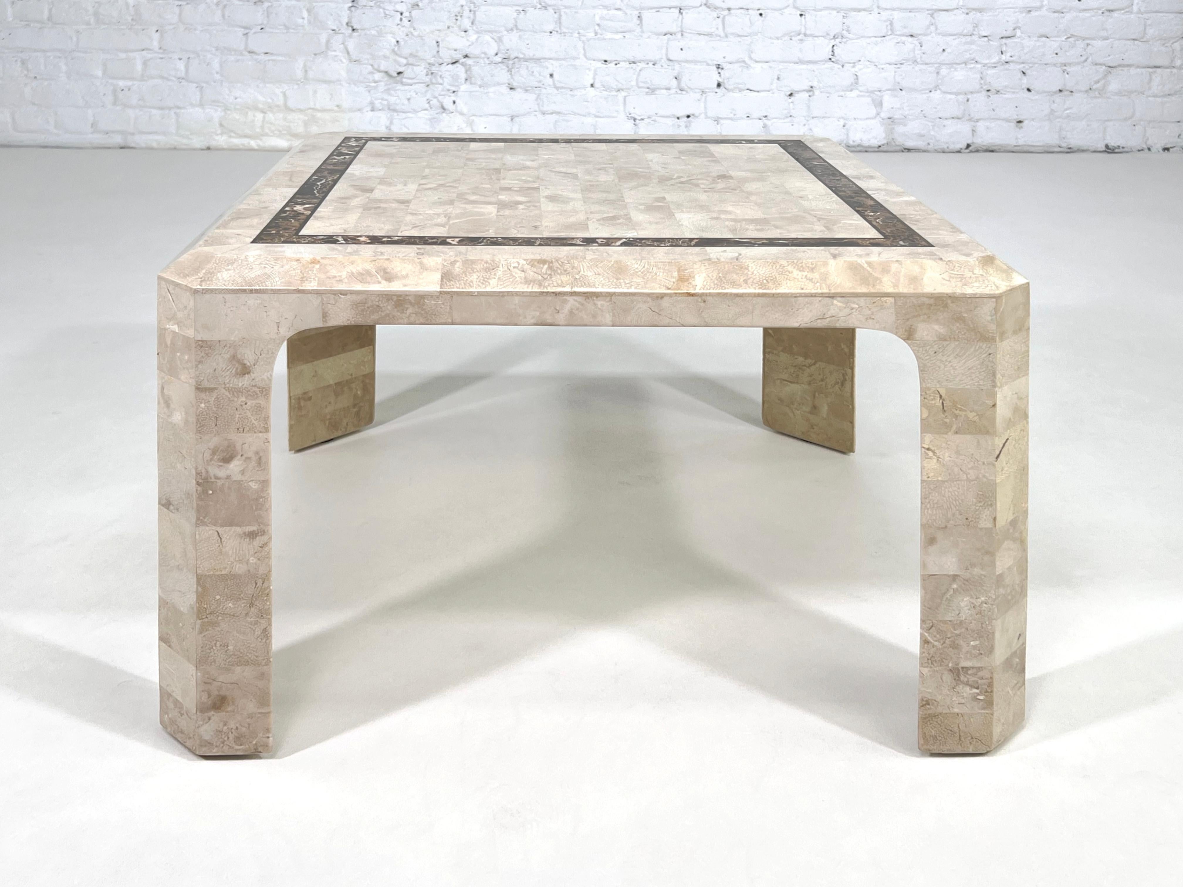 Hollywood Regency style square shaped coffee table with stone marquetry finely made: the entire structure of the table is dressed with travertine pieces marquetry, polished finishes and stone inlay. Hollywood Regency style, glamor 1970s, all in