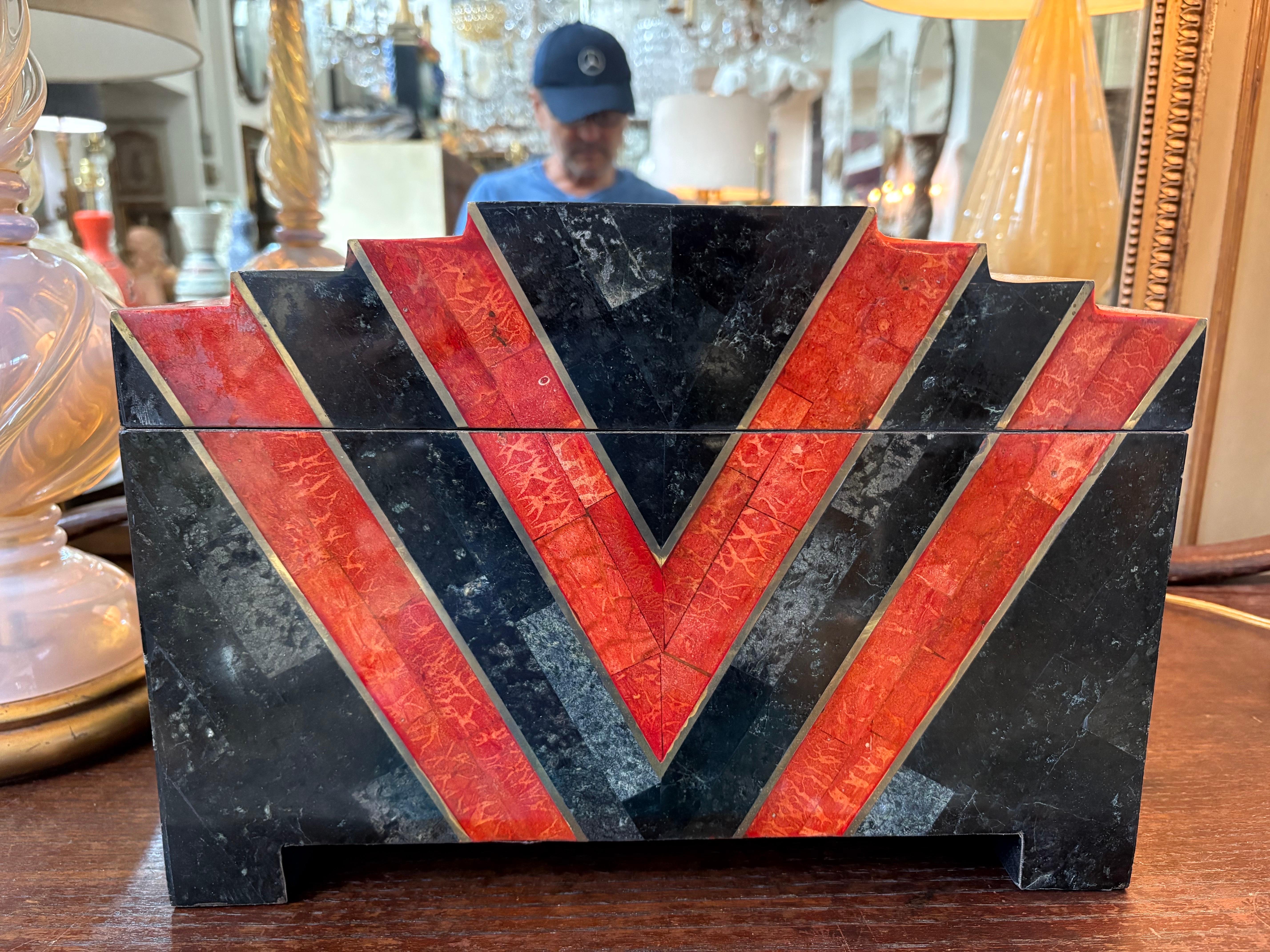 Maitland Smith Tessellated Stone Table Box.
Offered is a very large decorative box of tessellated stone in black and orange in the geometric Art Deco style created by Maitland Smith. This handsome box is the perfect cocktail table or bookcase