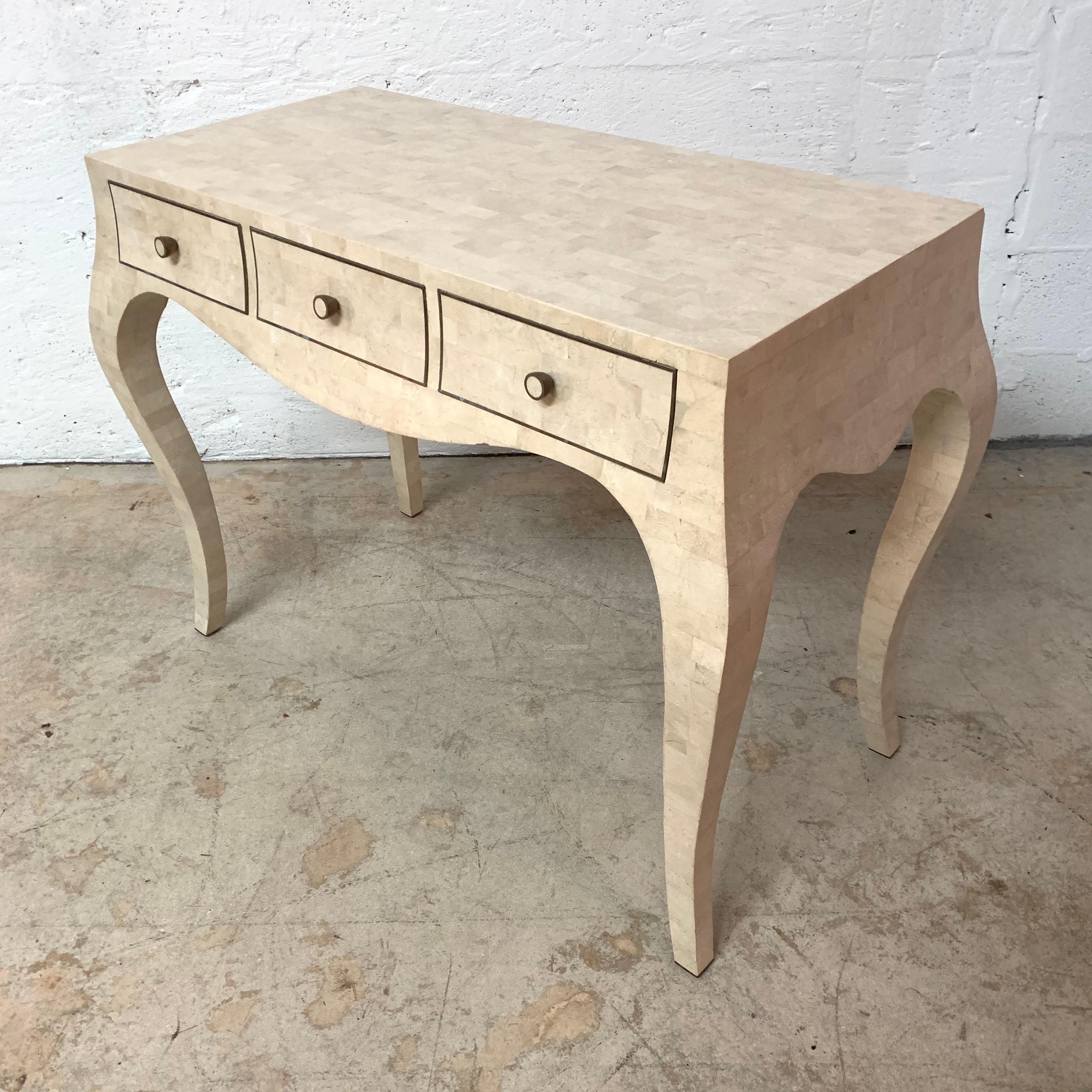 Desk or console table with cabriolet legs and 3 drawers rendered in tessellated cream ivory coral stone travertine with inlayed brass banding and knobs by Maitland Smith, Philippines, 1970s.