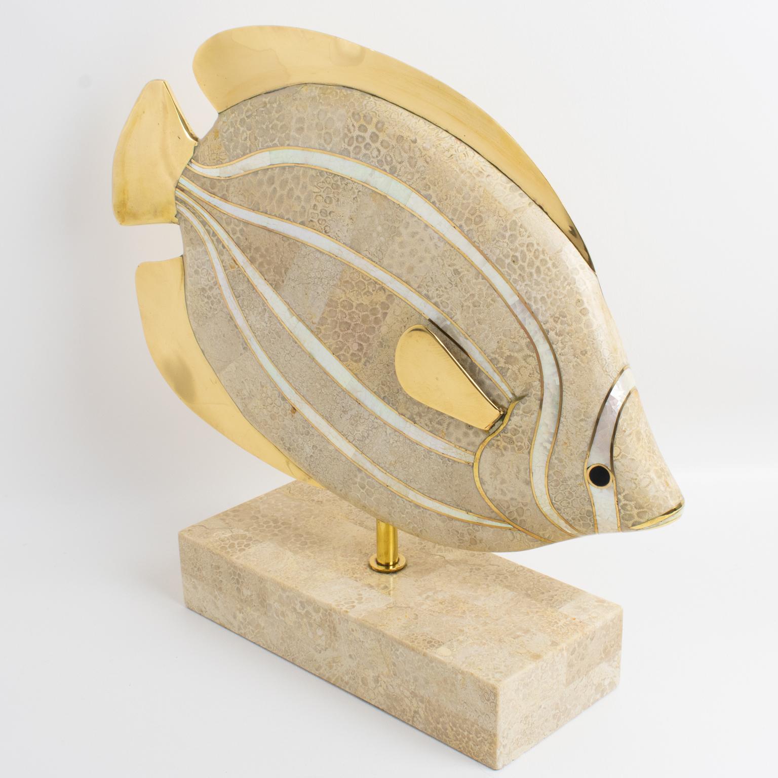 A beautiful sculpture designed by Maitland-Smith, and featuring an oversized fish. The fish table sculpture is made of stone veneered (marble and travertine) with gilded brass and seashell inlaid. The fish has a precious black stone eye on each