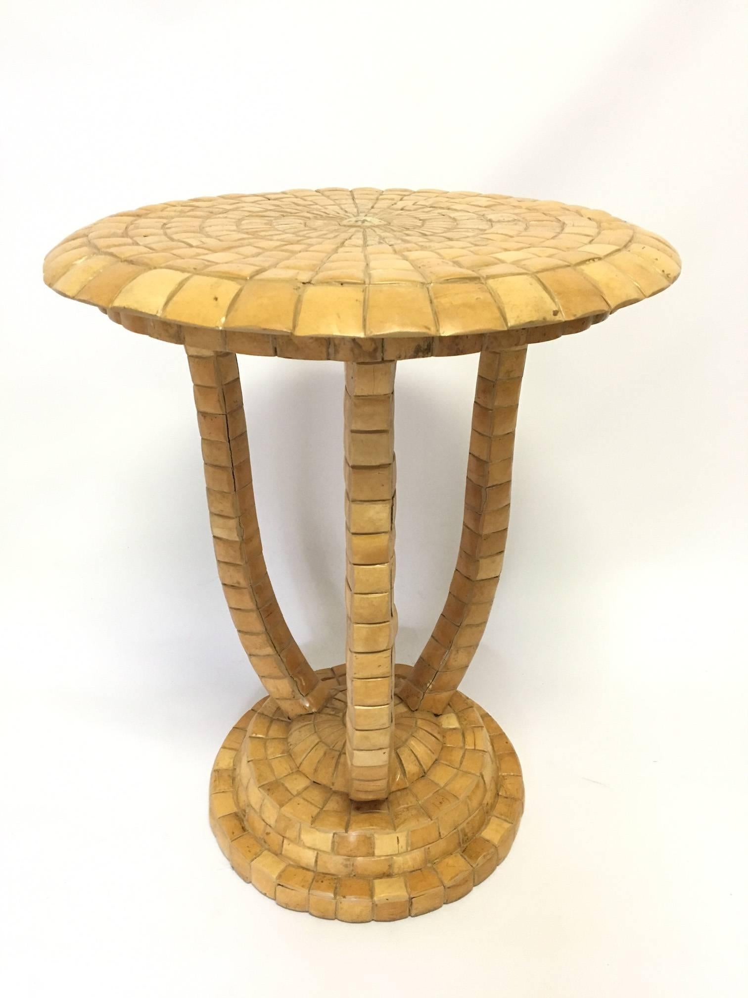 Tall Maitland Smith side table covered in a mosaic of small tiles that appear to be shell or bone. Very heavy and well constructed. Very good condition with some spacing appearing between tiles, yet all tiles are very firmly intact.
As always, all