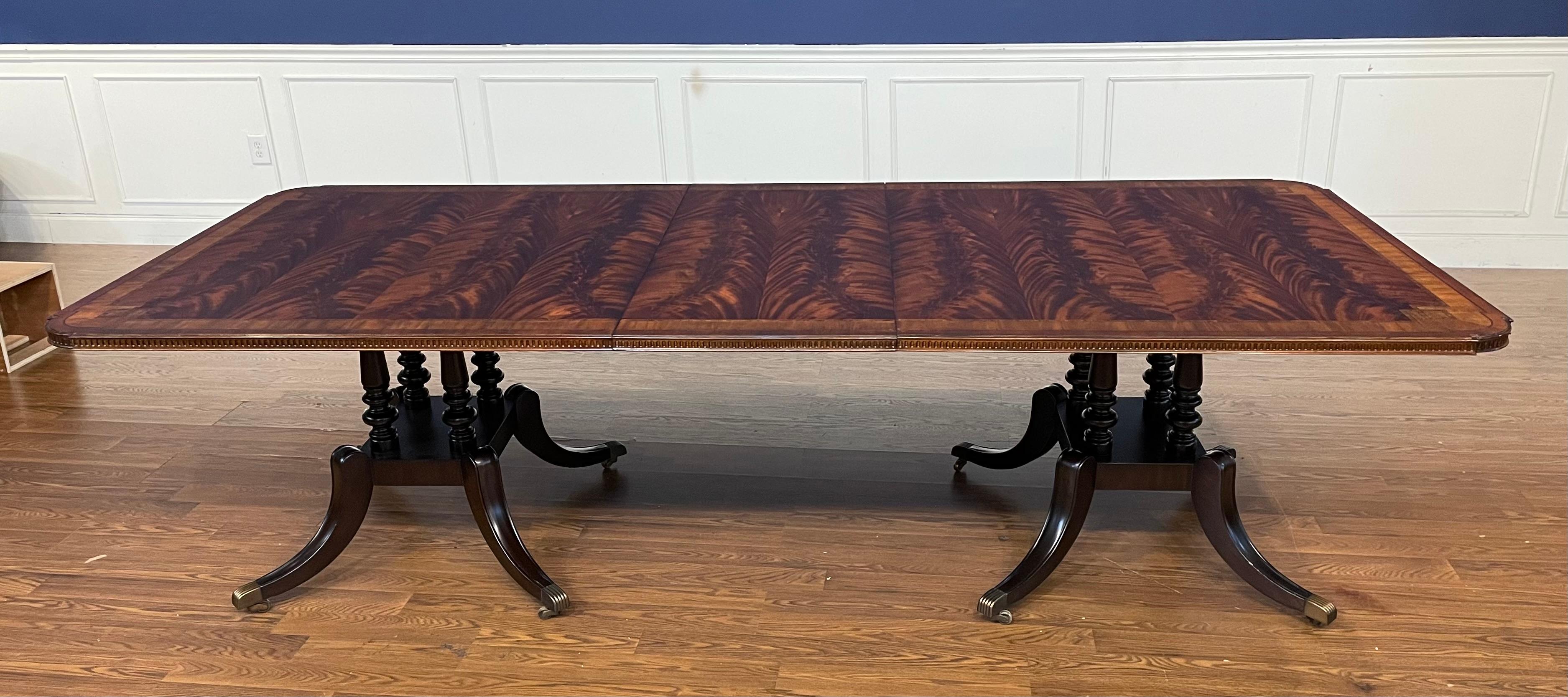This is the Mahogany Greek Key Dining Table by Maitland - Smith.  It features a top with a swirly crotch mahogany field and two contrasting borders, Greek Key inlay design in the corners and a mildly distressed satin/semigloss finish.  It has two