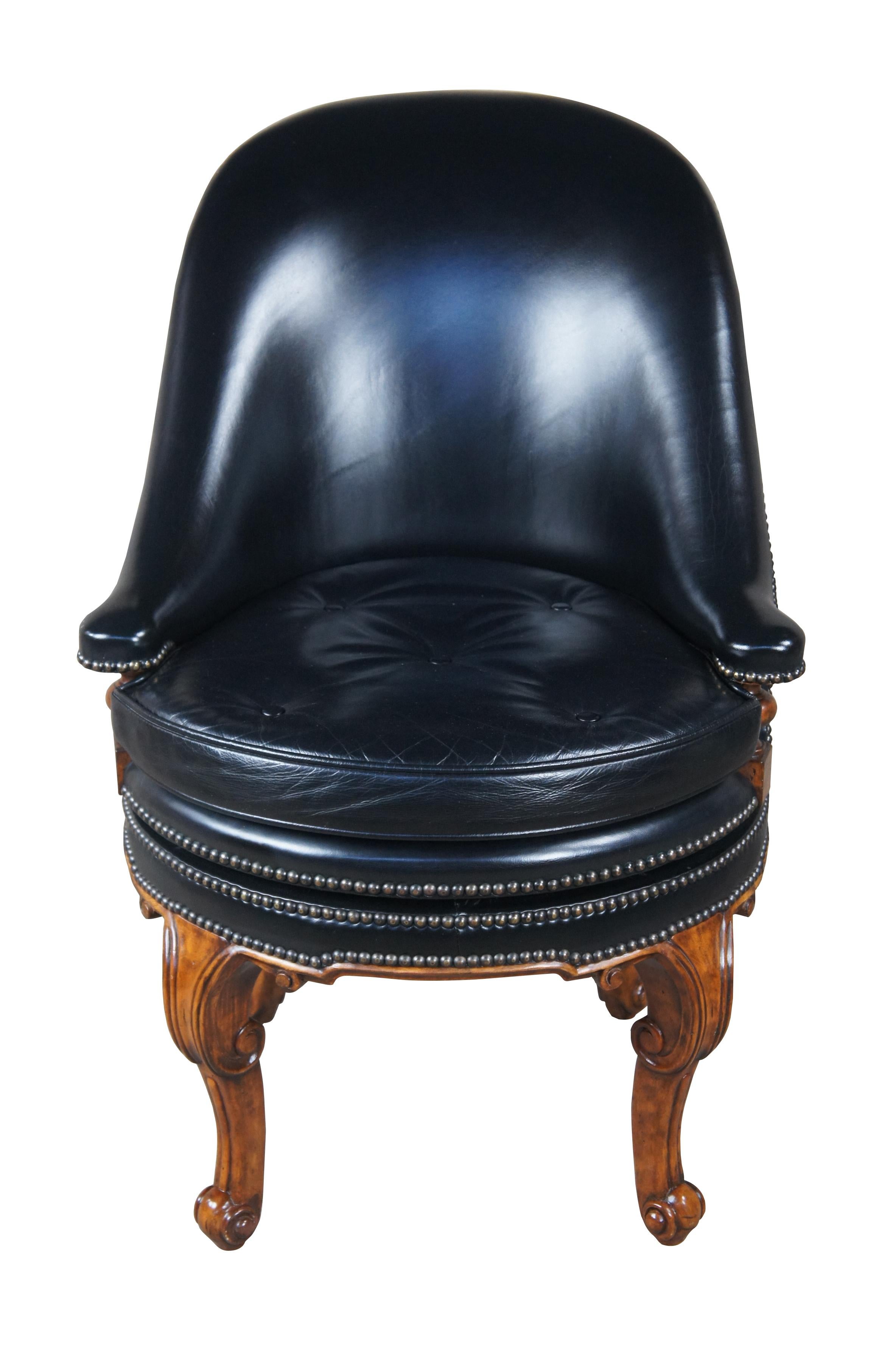 A beautiful Maitland Smith game, desk or occasional chair, 4330-810. French inspired with Napoleon Brown finished cabriole legs and Hemingway Black leather upholstery with brass tack accents and button tufted seat. The chair has a 90 degree swivel
