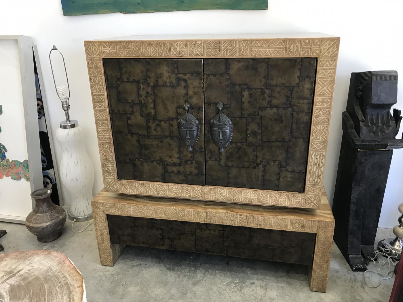 Very unique signed Miatland Smith tv stand in good vintage condition with many details.This tv stand has black leather on the inside.The leather needs to be restored. The top of this cabinet its not attached to the bottom part but it rests on it.