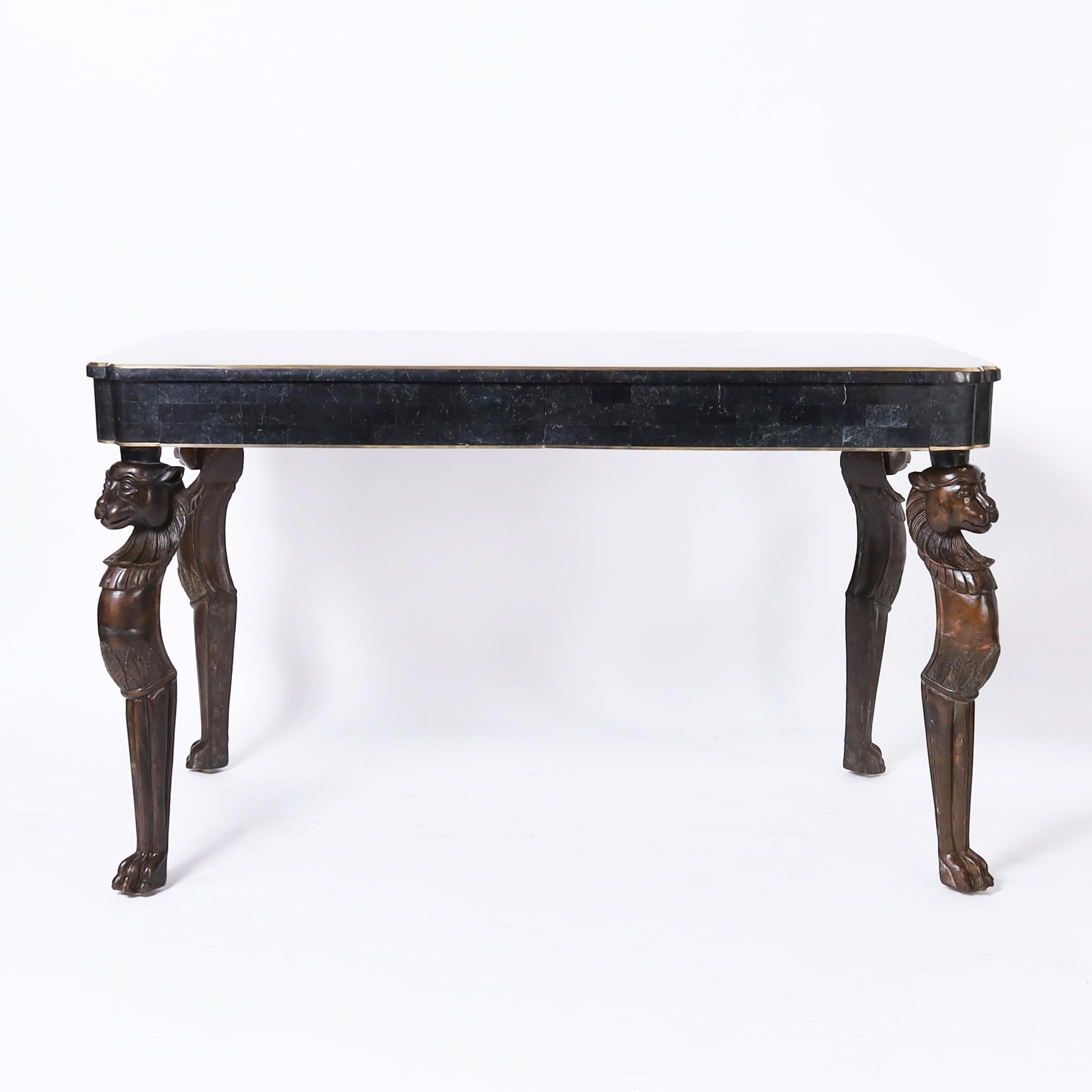 Standout mid century writing desk having a tessellated marble top on a case with two drawers and brass borders over four dramatic bronze Egyptian style cat legs. Signed Maitland-Smith in a drawer.