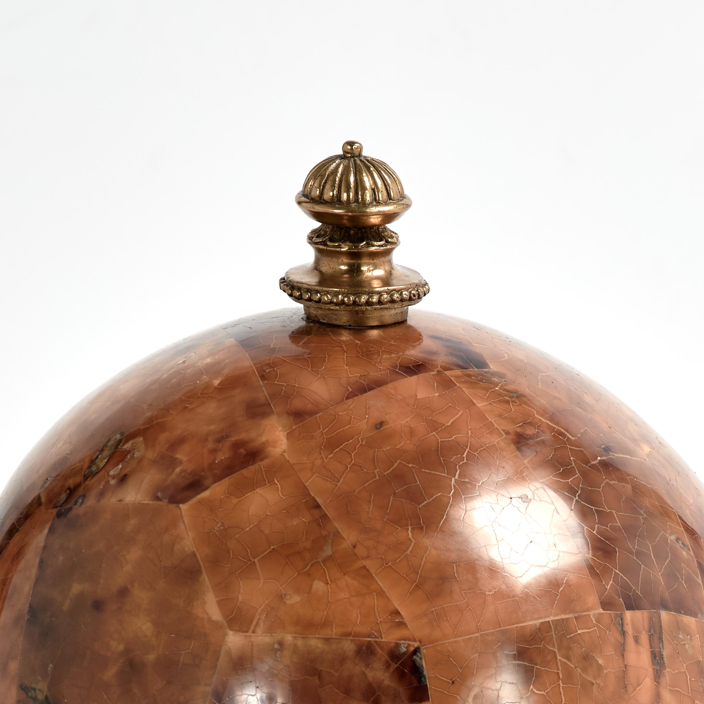 Standout mid century bin or coffer handcrafted with a brass handle on a faux tortoise shell lid over a mother of pearl bin with a mahogany lining. Signed Maitland-Smith on the bottom.
