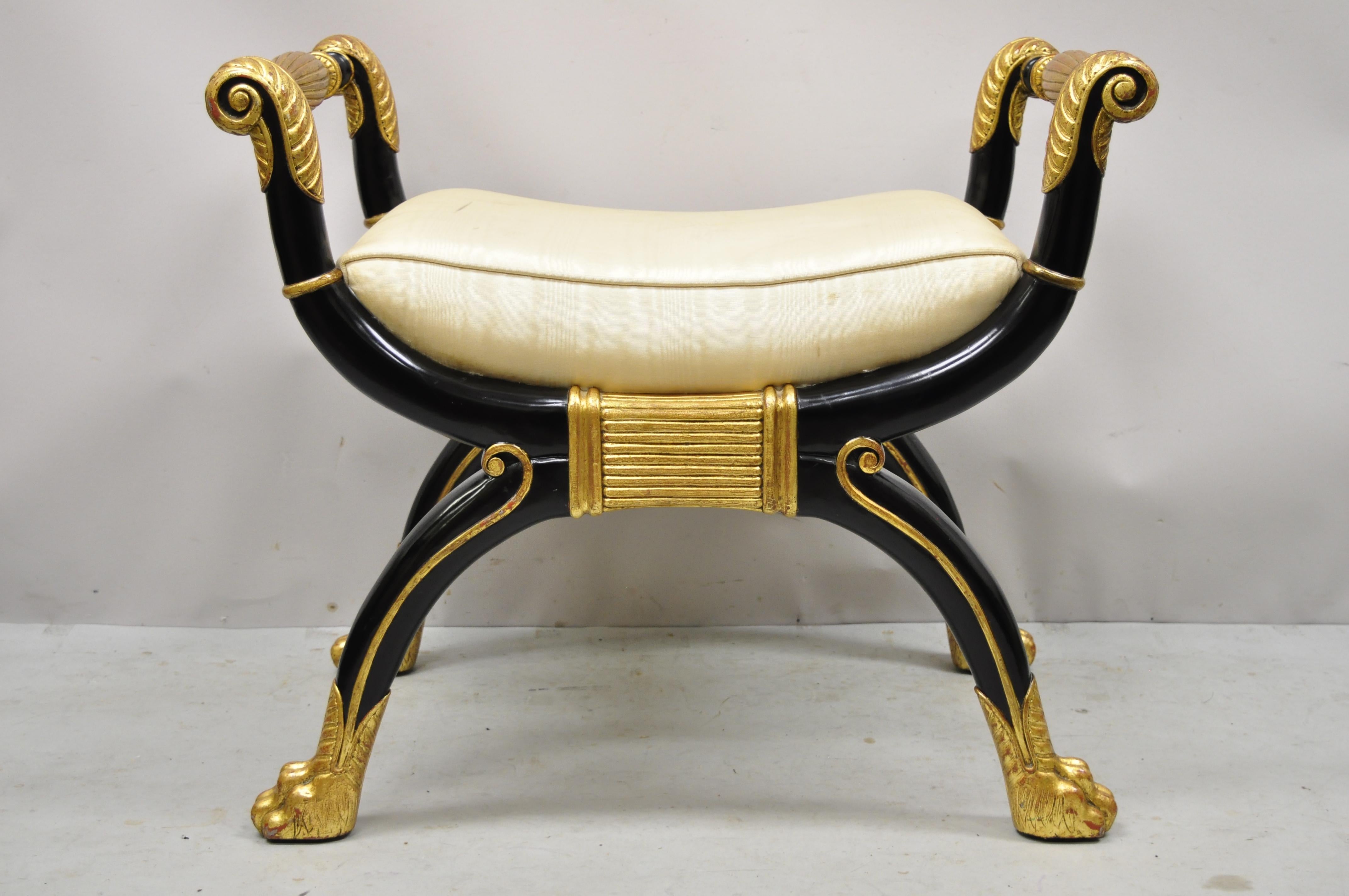 Maitland Smith X-Frame neoclassical regency style black gold curule bench. Item features a black and gold finish, solid wood frame, upholstered seat, nicely carved details, original label, carved paw feet, quality craftsmanship, great style and