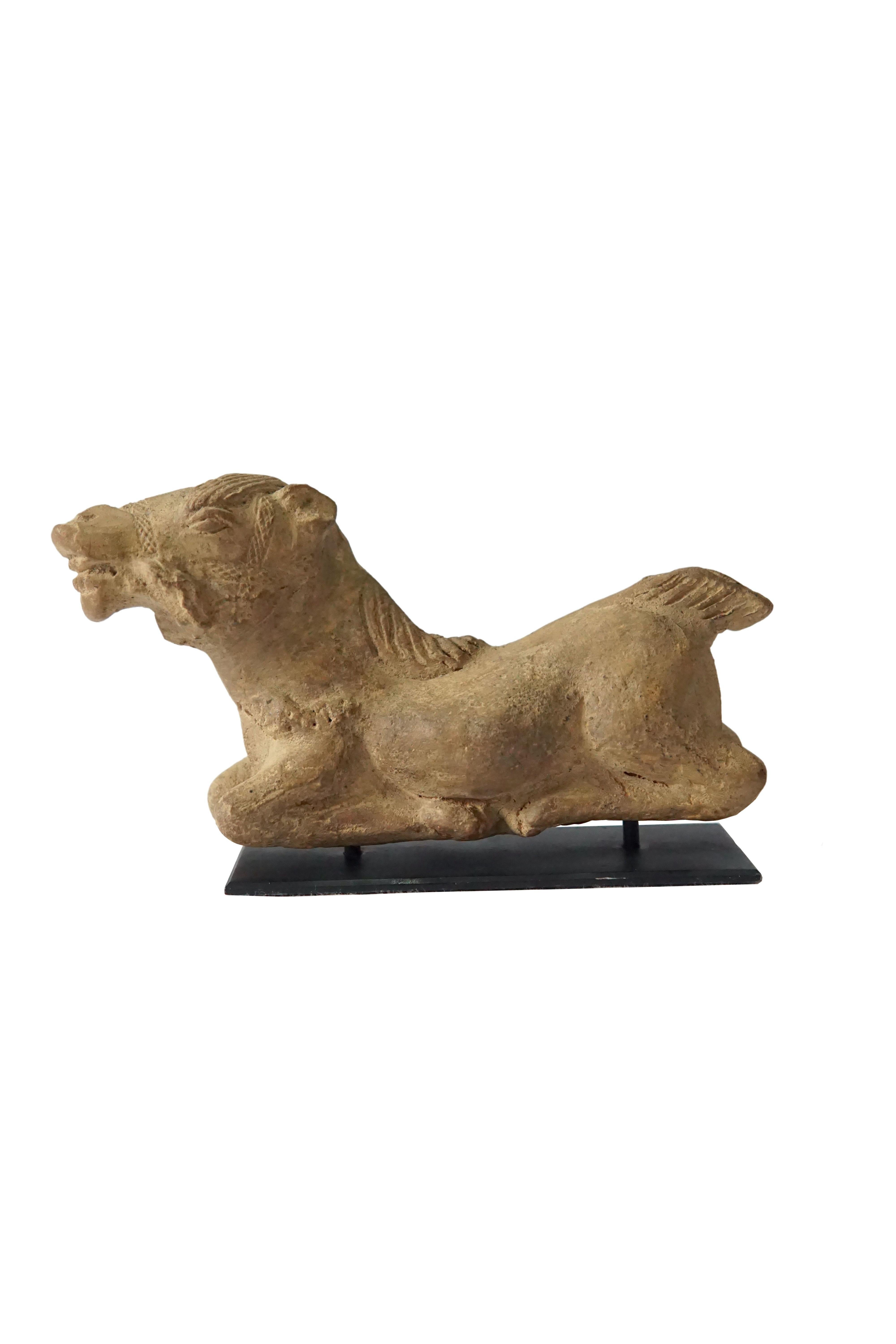 This Majapahit horse is crafted from terracota and is mounted on a stand. It was excavated amongst the shrines of Mount Penganggungan, East Java, Indonesia. Terracotta pottery was an important craft during the Majapahit era. This horse still
