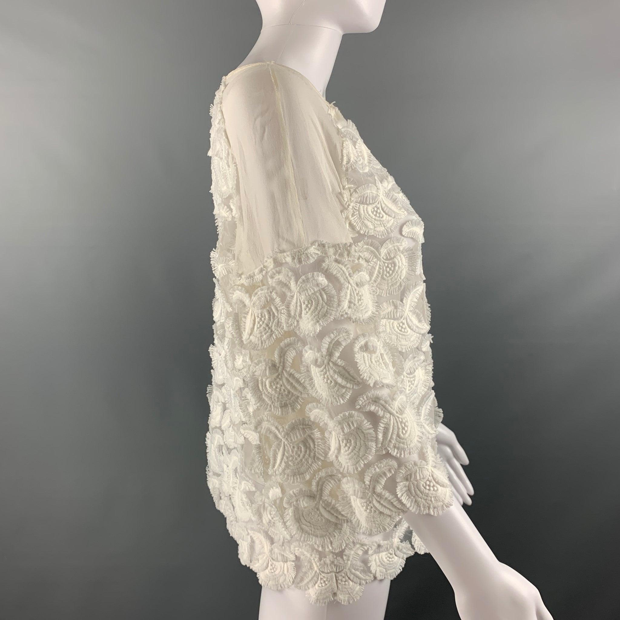 MAJE short sleeve dress top comes in a white polyester blend lace featuring a 3/4 and raglan sleeves.Very Good Pre-Owned Condition. Minor signs of wear. 

Marked:  no size marked 

Measurements: 
 
Shoulder: 16 inches Bust: 42 inches Sleeve: 15