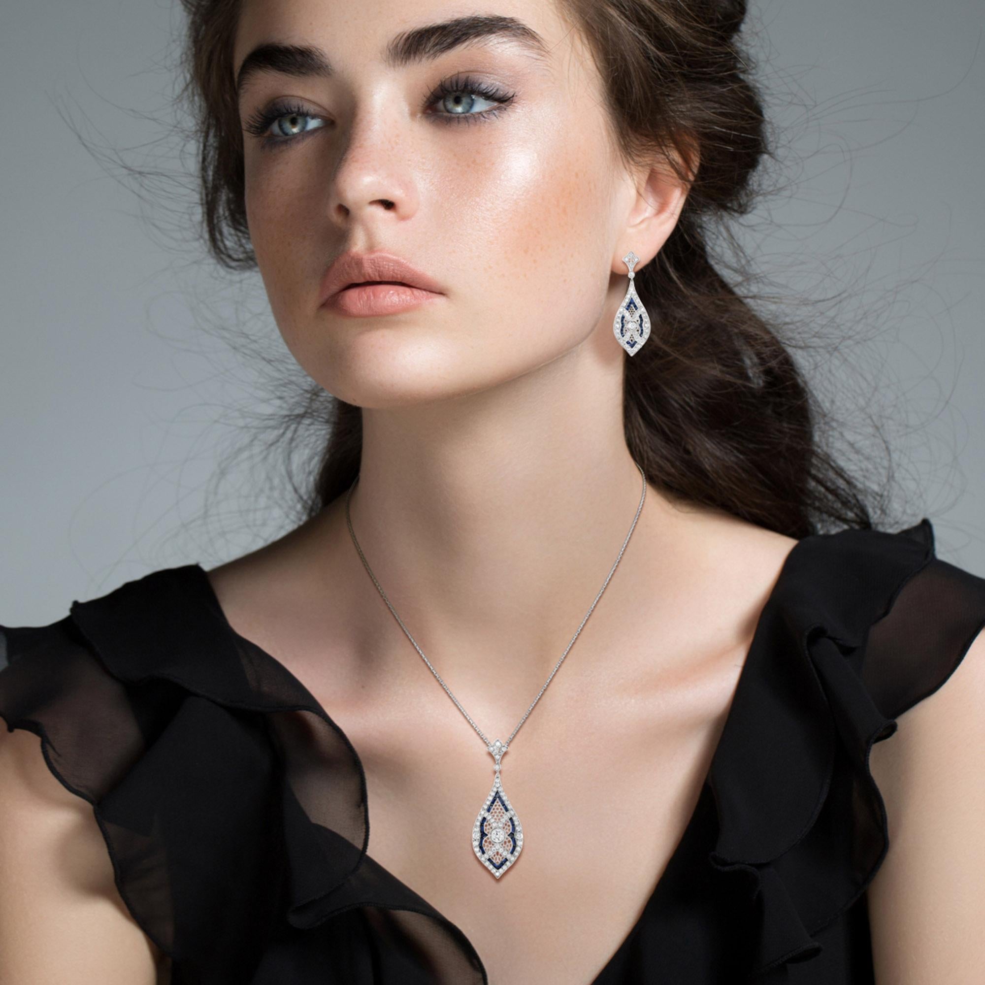 A pair of Art Deco style emerald and diamond pendant, set with French cut sapphires and round cut diamonds on open-work marquise shaped setting. Mounted in 14k white gold. A glamorous complement to an Art Deco female look. The pendant is perfectly
