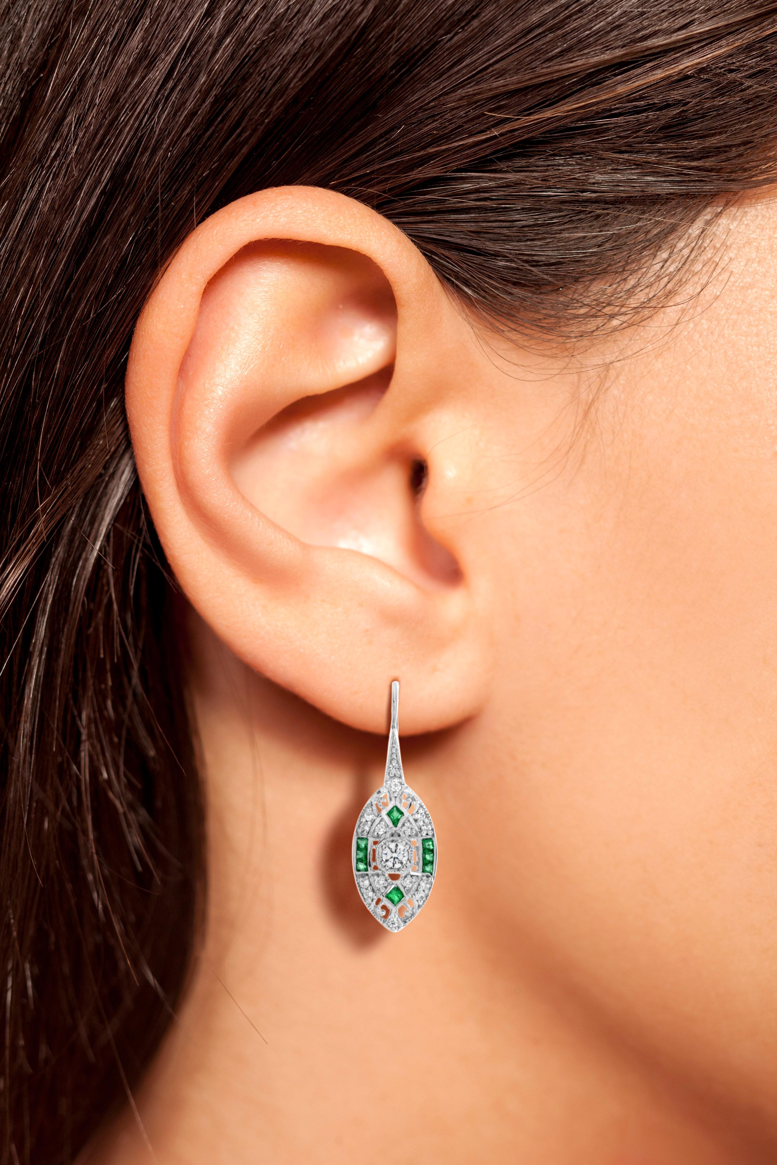 A pair of Art Deco style emerald and diamond lever back earrings, set with French cut emeralds and round cut diamonds. Mounted in 14k white gold.

Information
Metal: 14K White Gold
Width: 8 mm.
Length: 25 mm.
Weight: 3.80 g. (approx. total