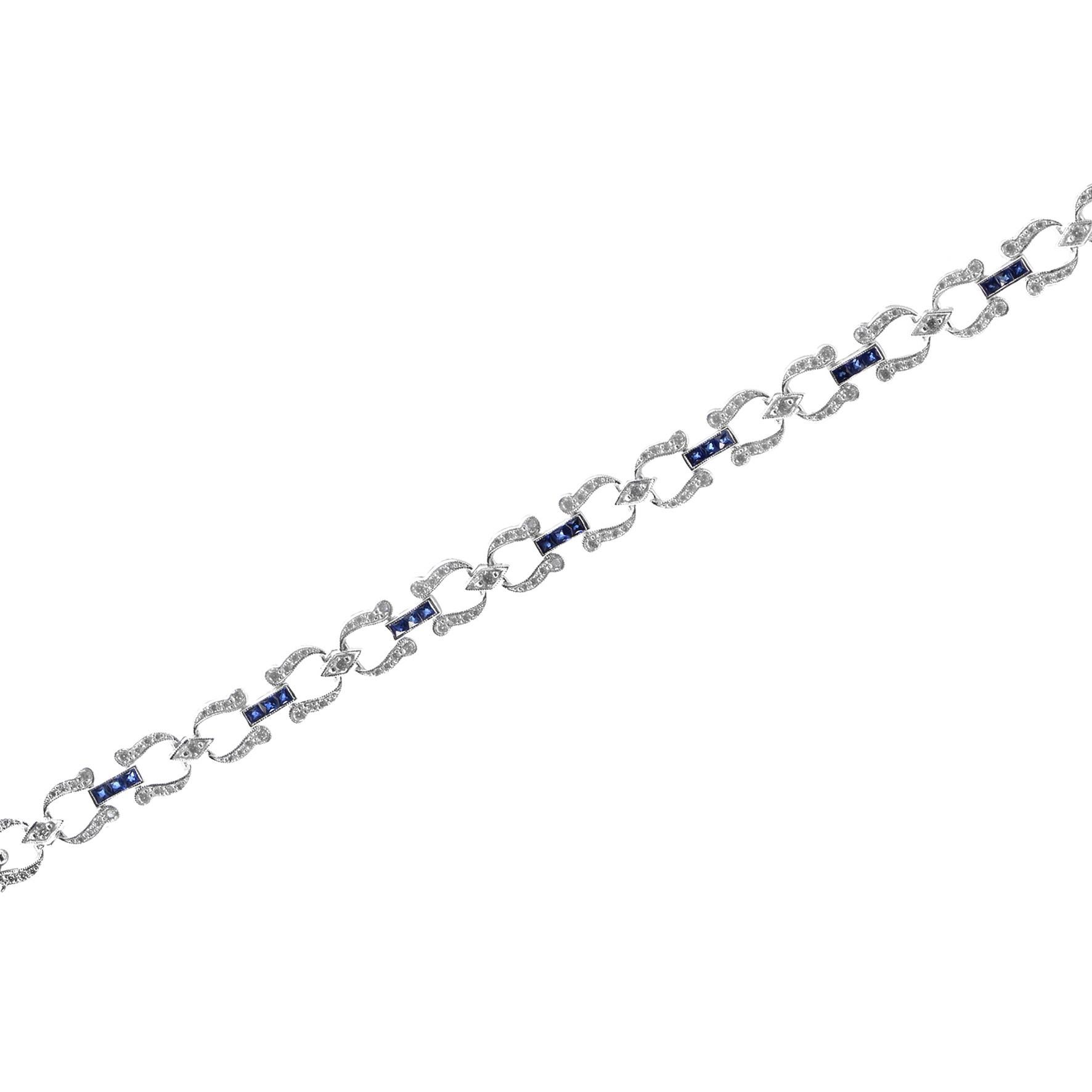 Handcrafted out of stunning French-cut blue sapphires and diamonds, this bracelet is perfect for evening or day wear. Each individual section features round diamonds and is separated from its neighbor with a sapphire line. This wonderful piece is a