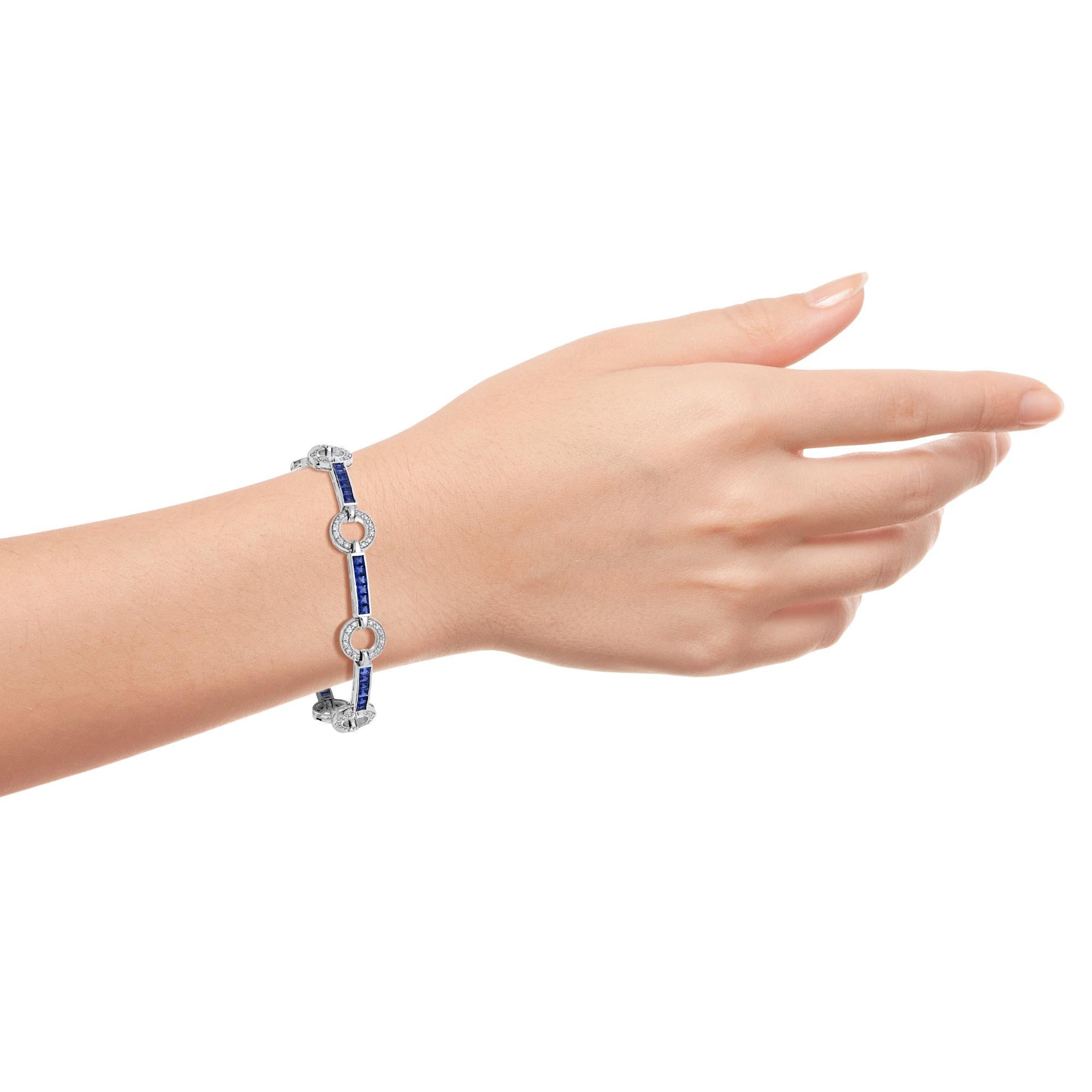 Handcrafted out of stunning blue sapphires and diamonds, this bracelet is perfect for evening or day wear. Each individual section features round diamonds and is separated from its neighbor with a sapphire line. This wonderful piece is a must-have