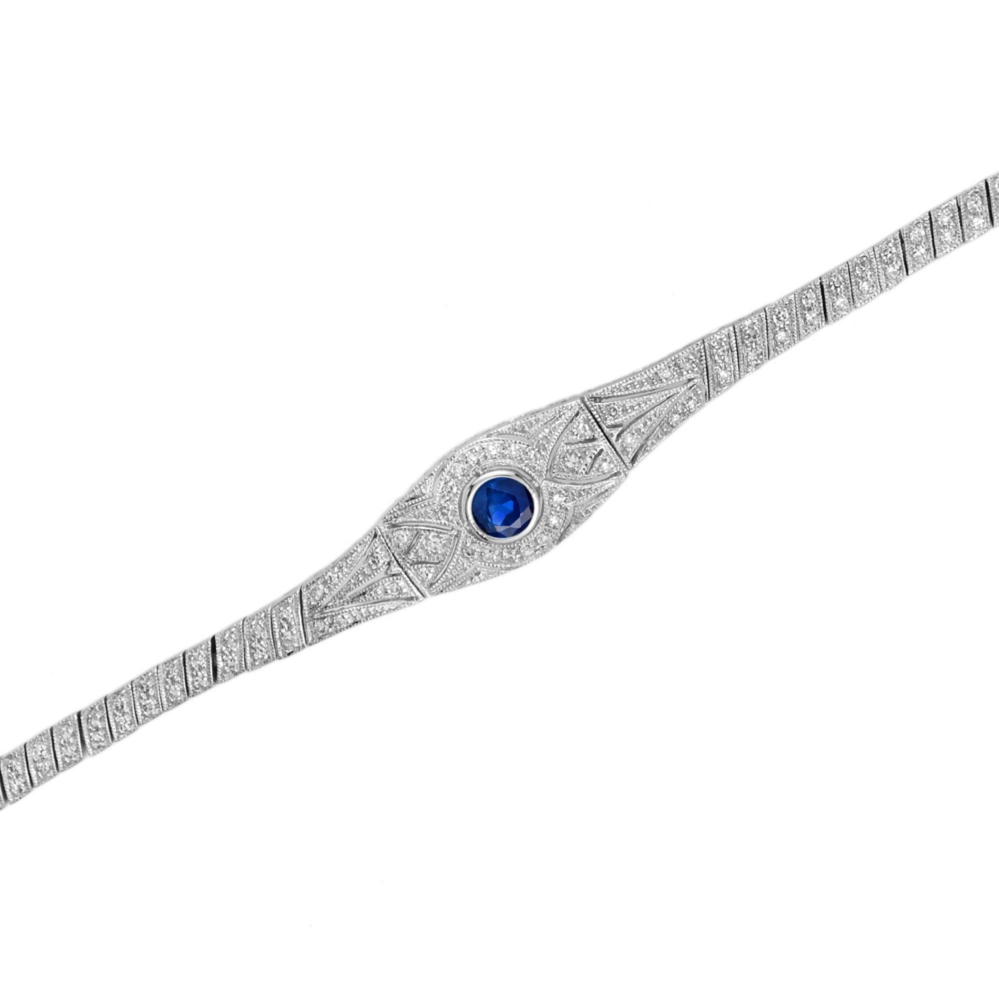 Wreath your wrist in a tremendous twinkling with this delectable sapphire and diamond bracelet in the Art Deco ear design. White gold forms a sleek single-row line bracelet with a wider, rounded central motif featuring scintillating blue