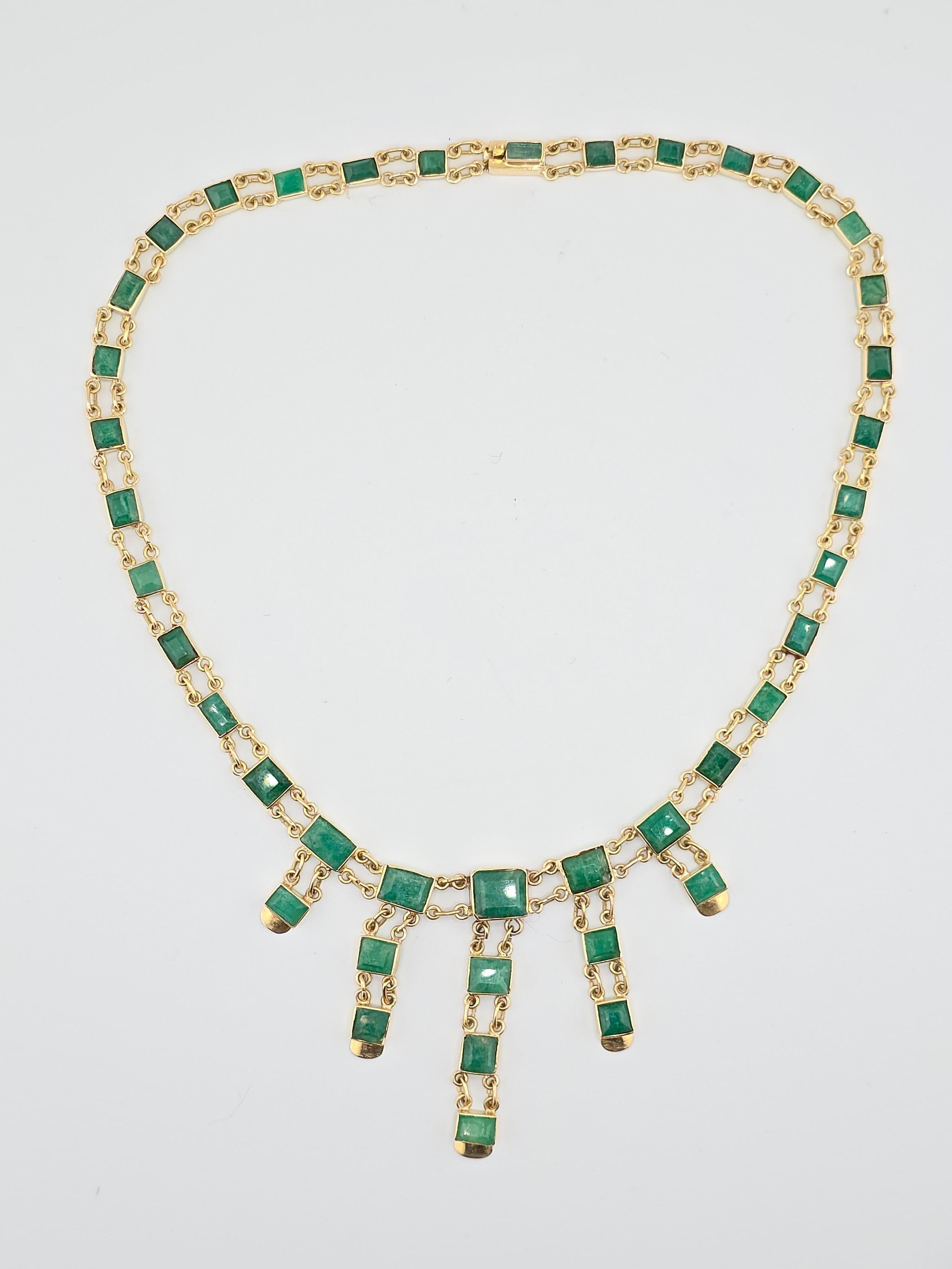 This is an exceptional large 14 karat yellow gold and emerald necklace. The colors on the emerald are vivid, green with different shades some lighter some darker. The total amount of carats easily exceed well over 20 carats but not sure of the exact