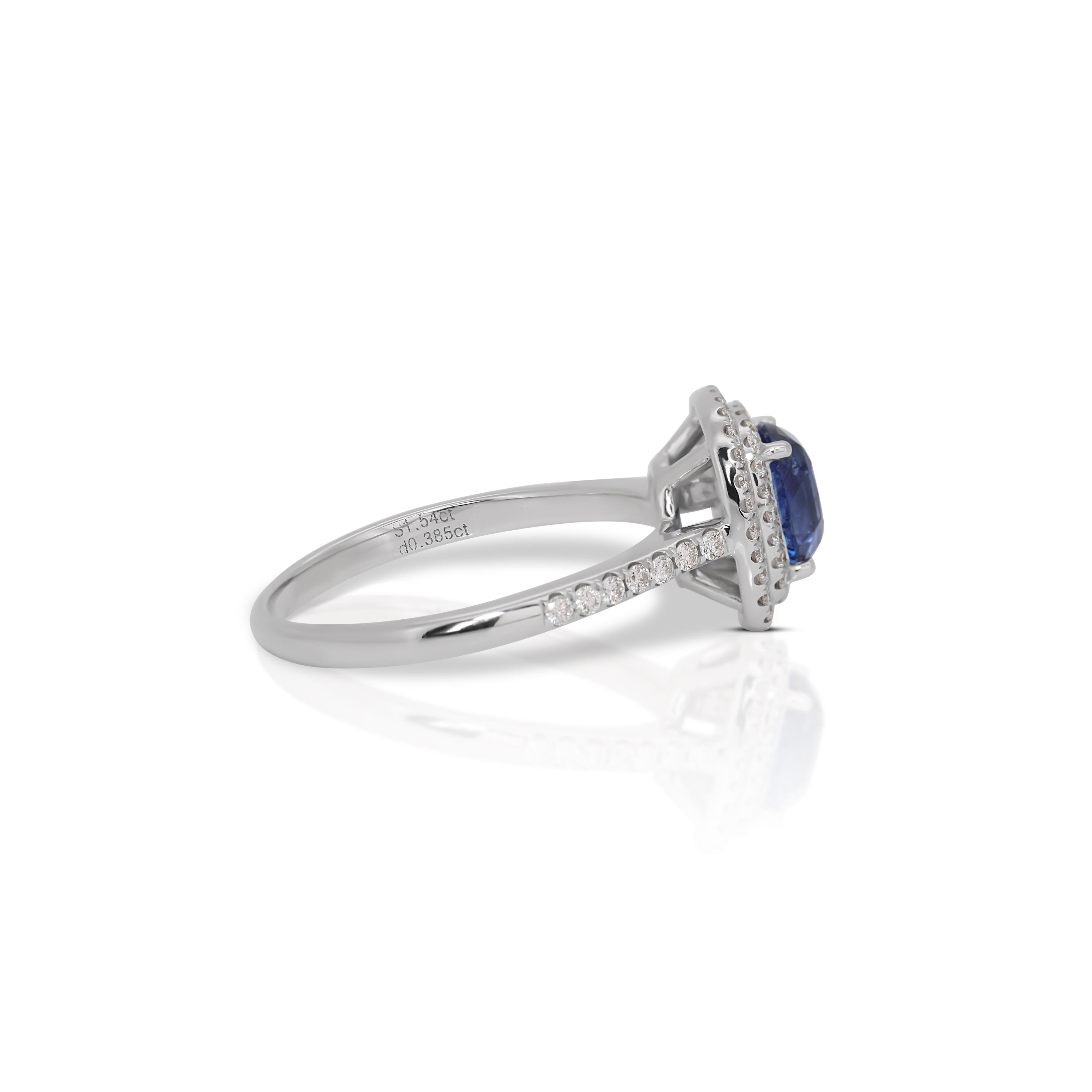 Majestic 18k White Gold Cushion Sapphire and Diamond Halo Ring w/2.21 ct - IGI Certified

Embrace the serene elegance of this 18k White Gold Halo Ring that captivates with its deep blue allure and radiant diamond halo. Central to its design is a