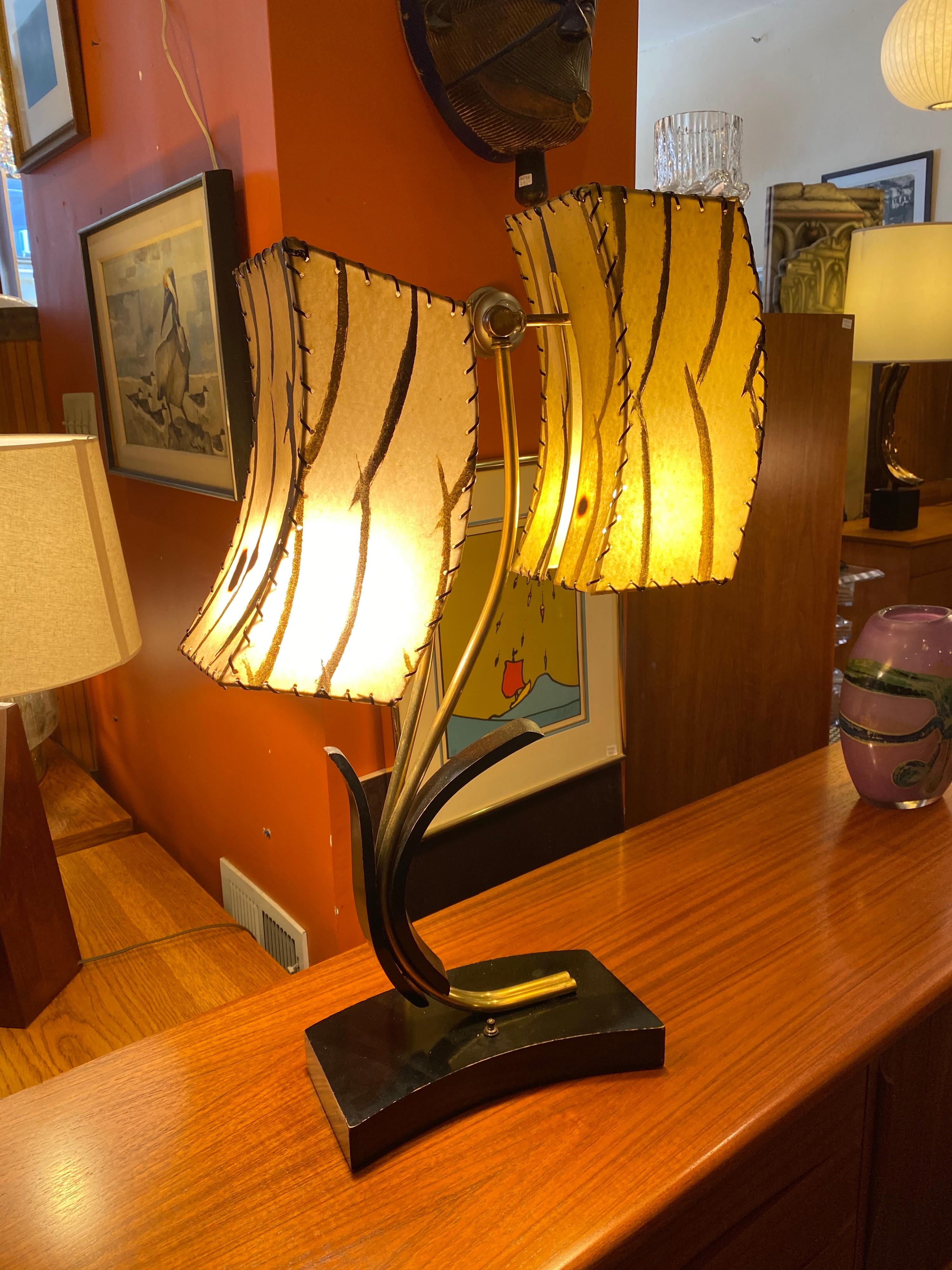 Majestic 2-shade table lamp. Fiberglass shades have all been re-gimped and lamp has been rewired. Classic midcentury look and feel! Fiberglass shades each have one burn spot as seen in photos. Switch turns one or two shades on!