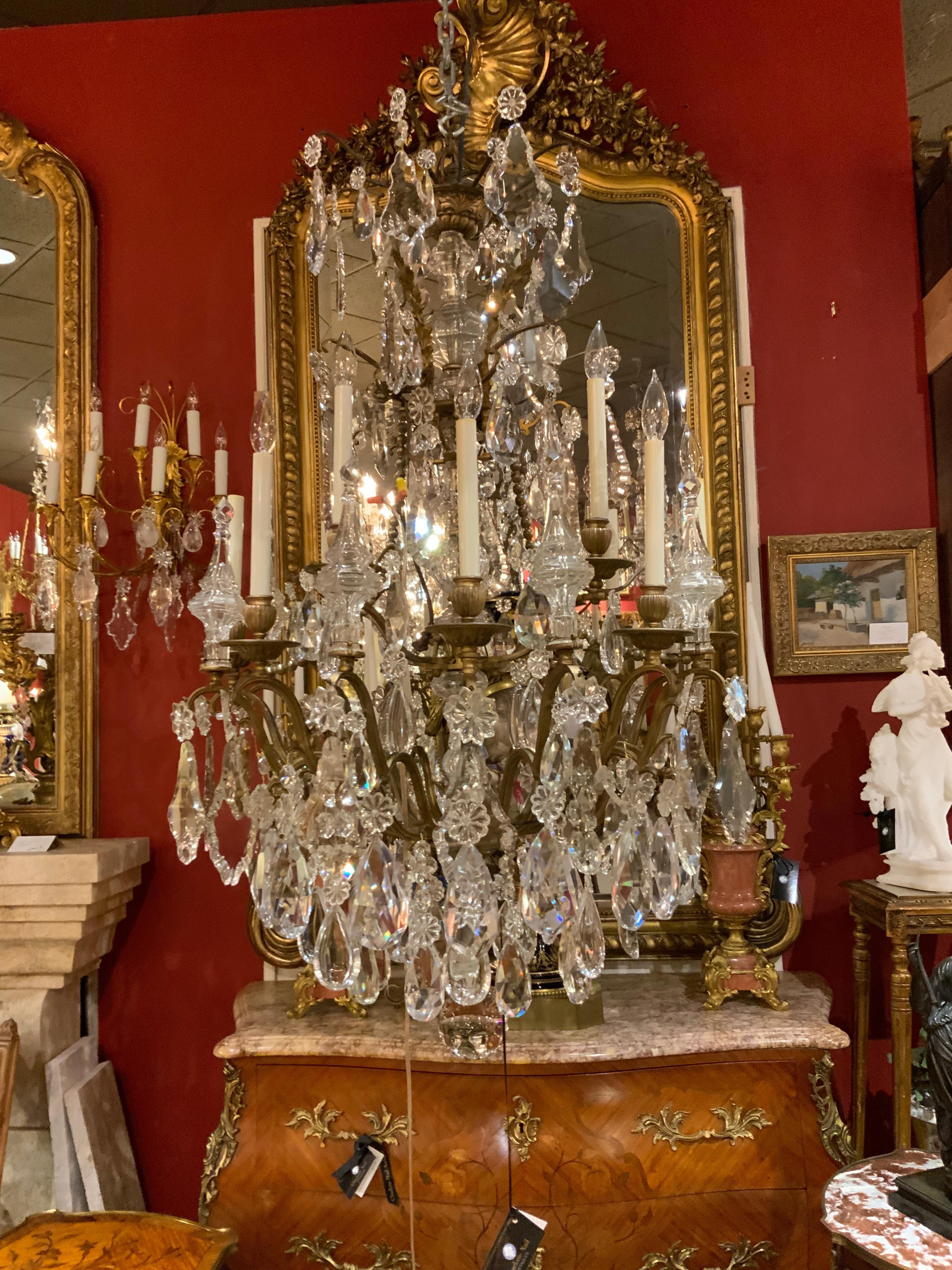 Antique French bronze and crystal chandelier with 12 lights. Scrolling arms with
Multiple spires. Central crystal post makes this piece especially beautiful.
