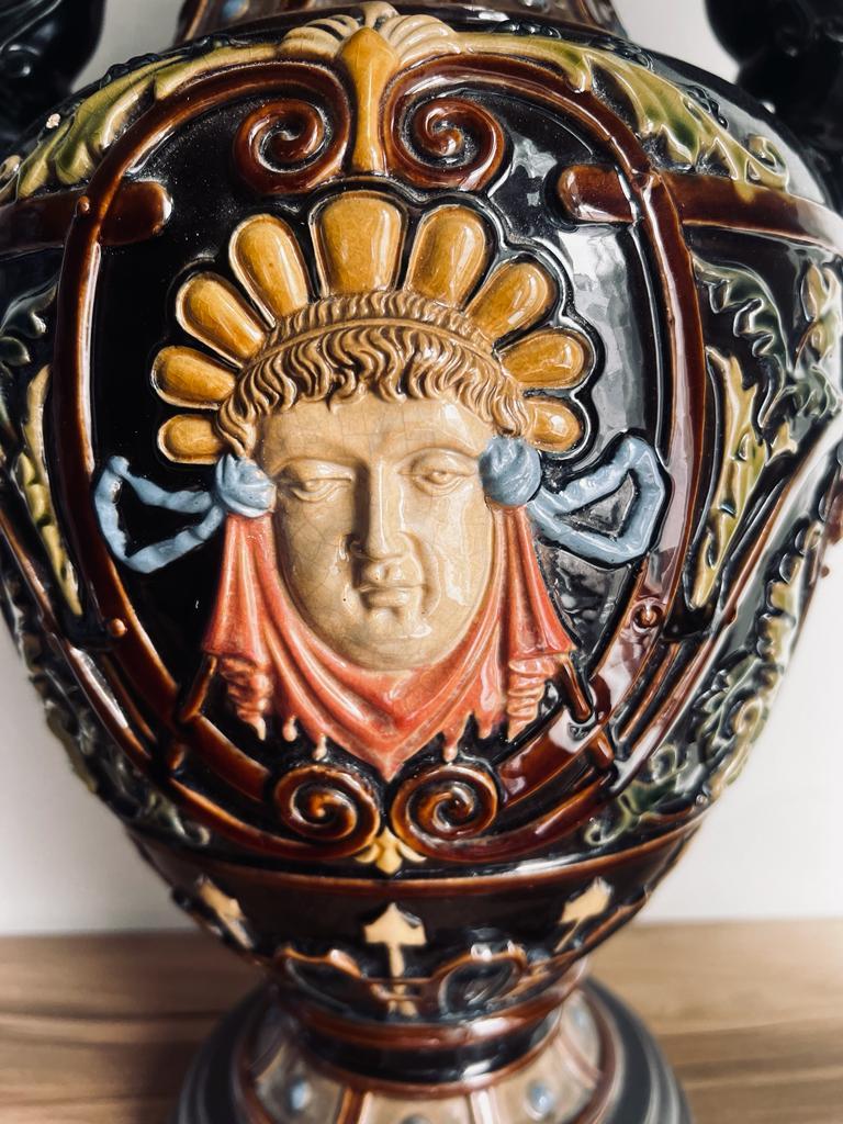 This is an absolutely beautiful Majolica porcelain Vase.
 It is 42 cm hight and has as its main theme the face of Dionysus -God of Wine in greek mythology. The handles are decorated with wine grapes and leaves. 