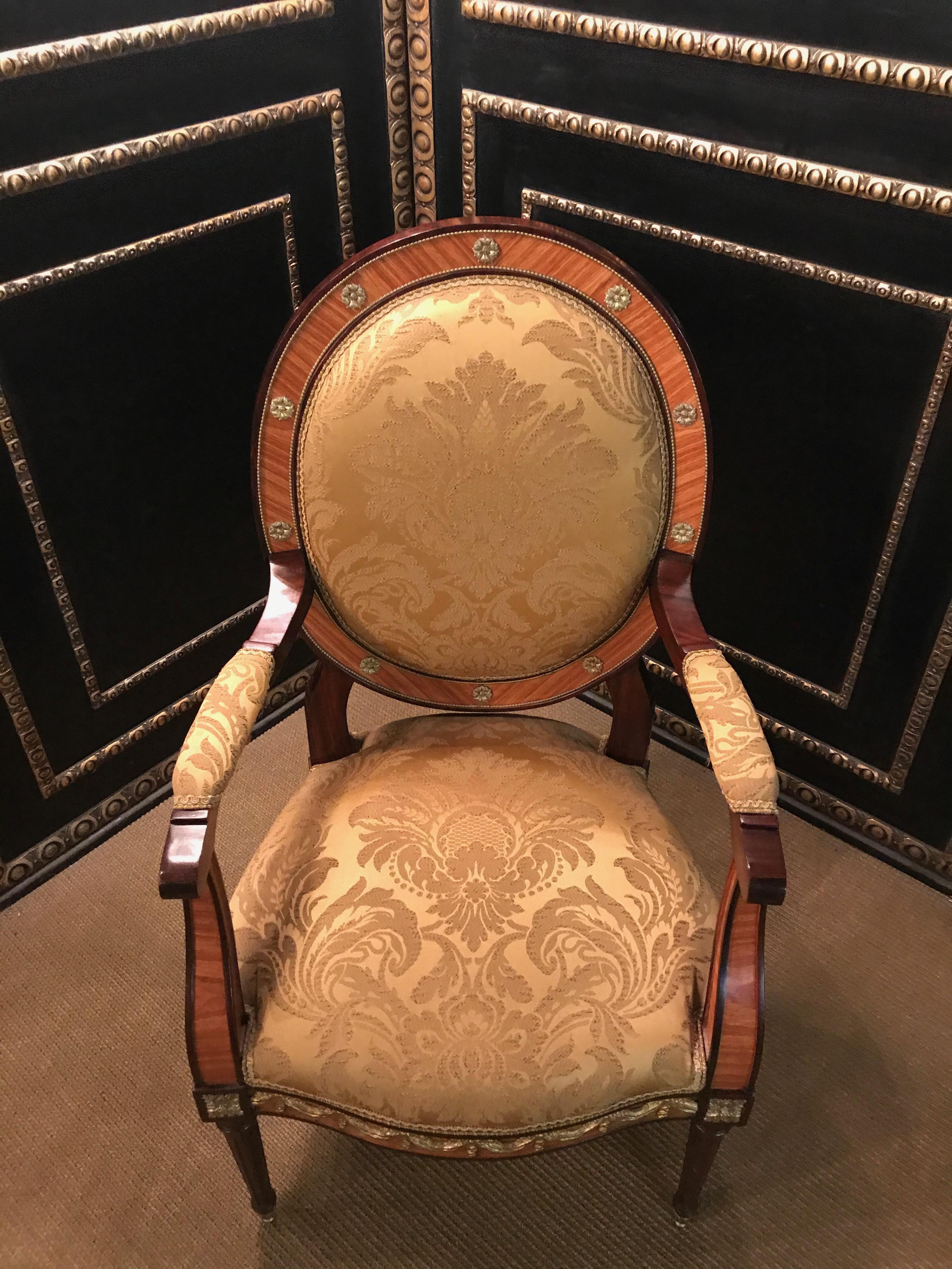 Majestic armchair in Louis Seize style

Bois-Satiné veneer, mirror veneer covering all sides on solid beech wood.

Cambered frame with richly decorated bronze in the form of fabric drapery on fluted, tapered legs ending in sabots. Curved