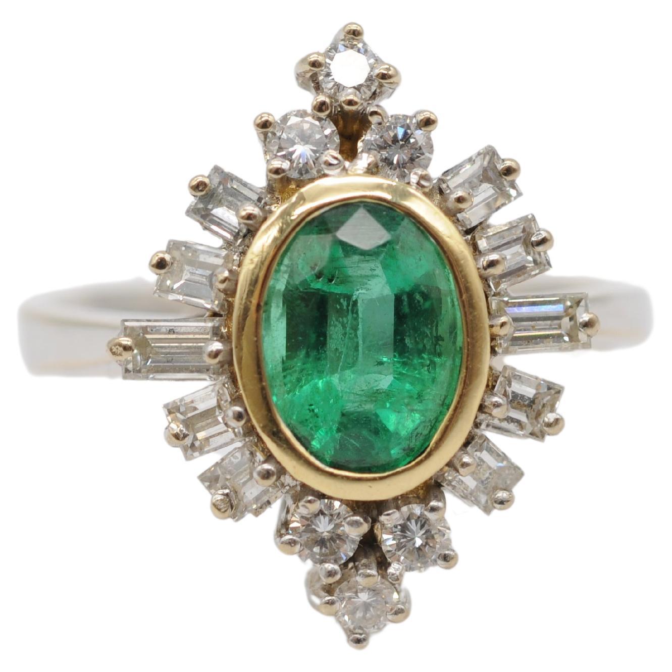 Behold the breathtaking beauty of this 18k white gold ring adorned with an exquisite Colombian emerald approx 1.25ct and sparkling diamonds. The centerpiece of this majestic piece is the oval-cut Colombian emerald, nestled within a yellow gold
