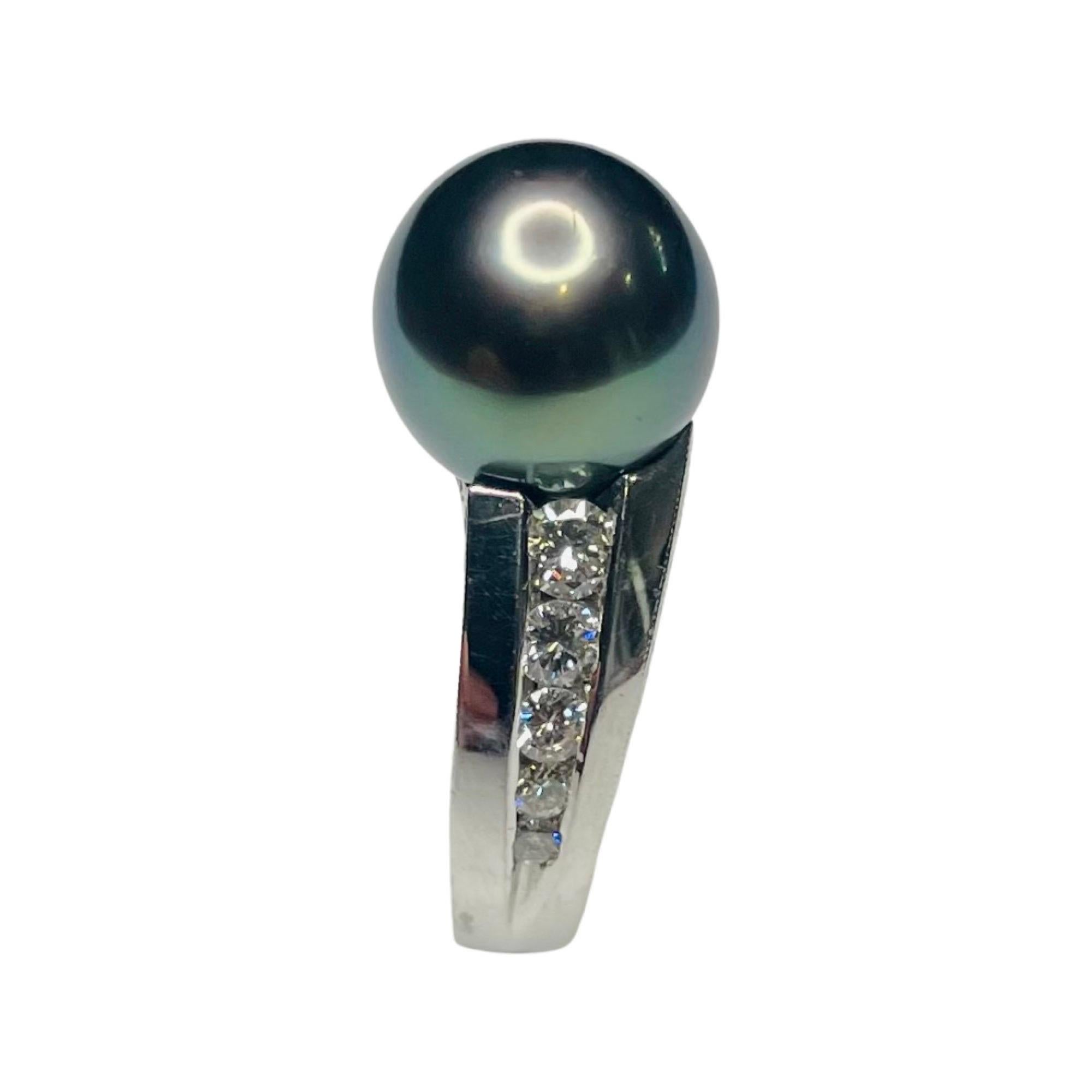 Majestic Art Platinum Cultured Natural Color Black Tahitian Pearl Hand Engraved Ring. The black Tahitian pearl is 10.6 mm.  The pearl is round with high luster and poe rava overtone. There are 10, channel set, full cut round brilliant diamonds for a
