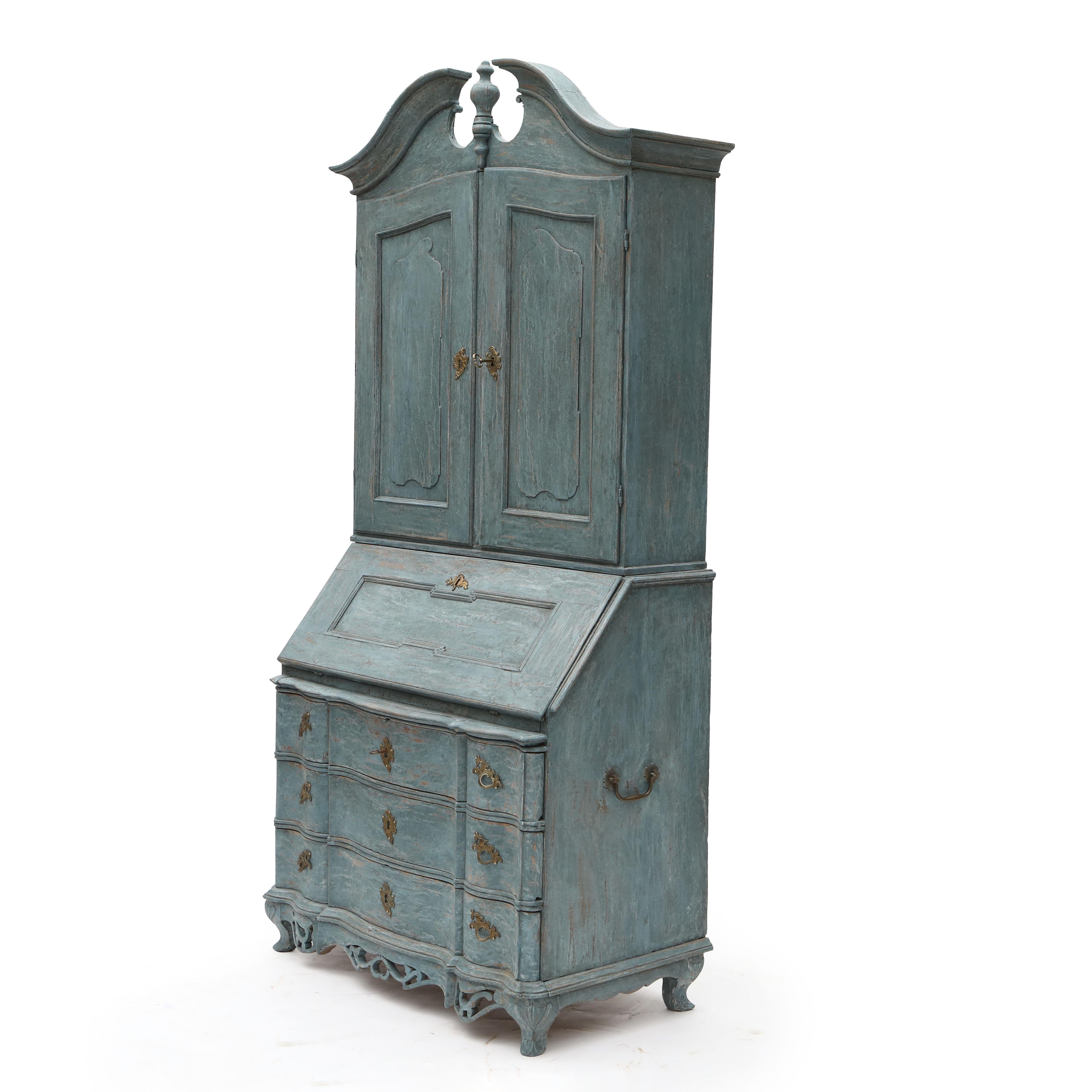 A Rococo secretary desk with a cabinet or bookcase top, beautifully painted in blue with a black-painted interior.

This piece consists of two sections: Upper section consists of a cabinet with a swan-neck pediment. The cabinet features a pair of