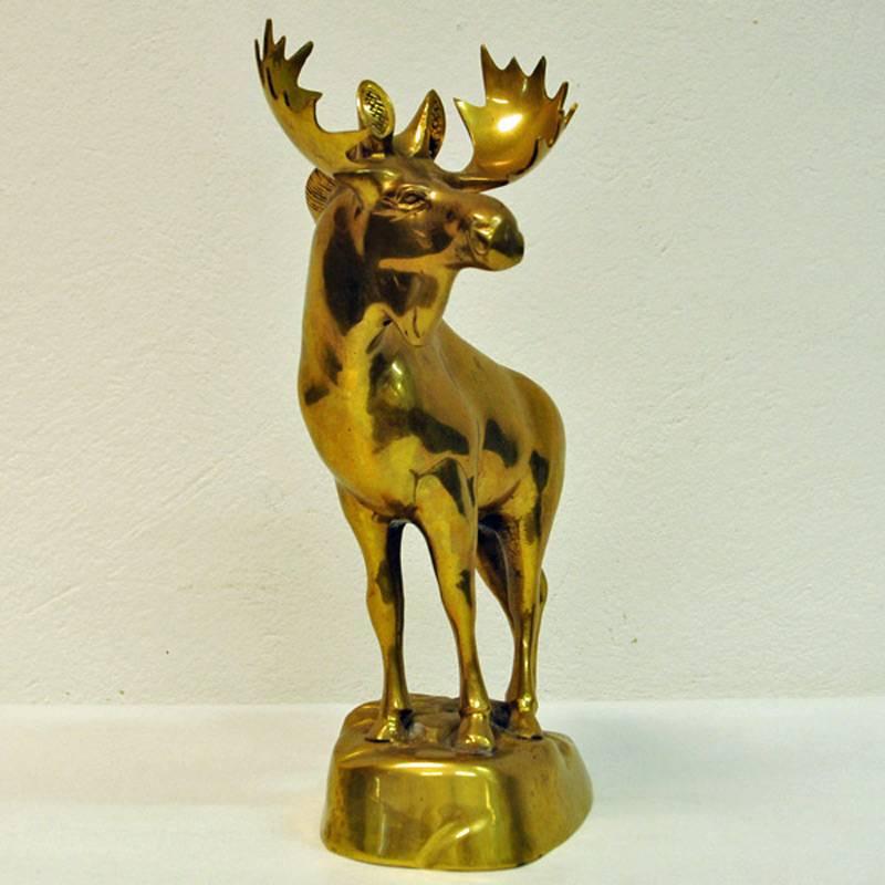 Beautiful and proud brass moose statue with realistic design details. Standing on a brass base. This majestic piece would look amazing displayed on a fireplace mantel or book shelf. Measure: Height 34 cm (front) and 20 cm height (back) length 26 cm,