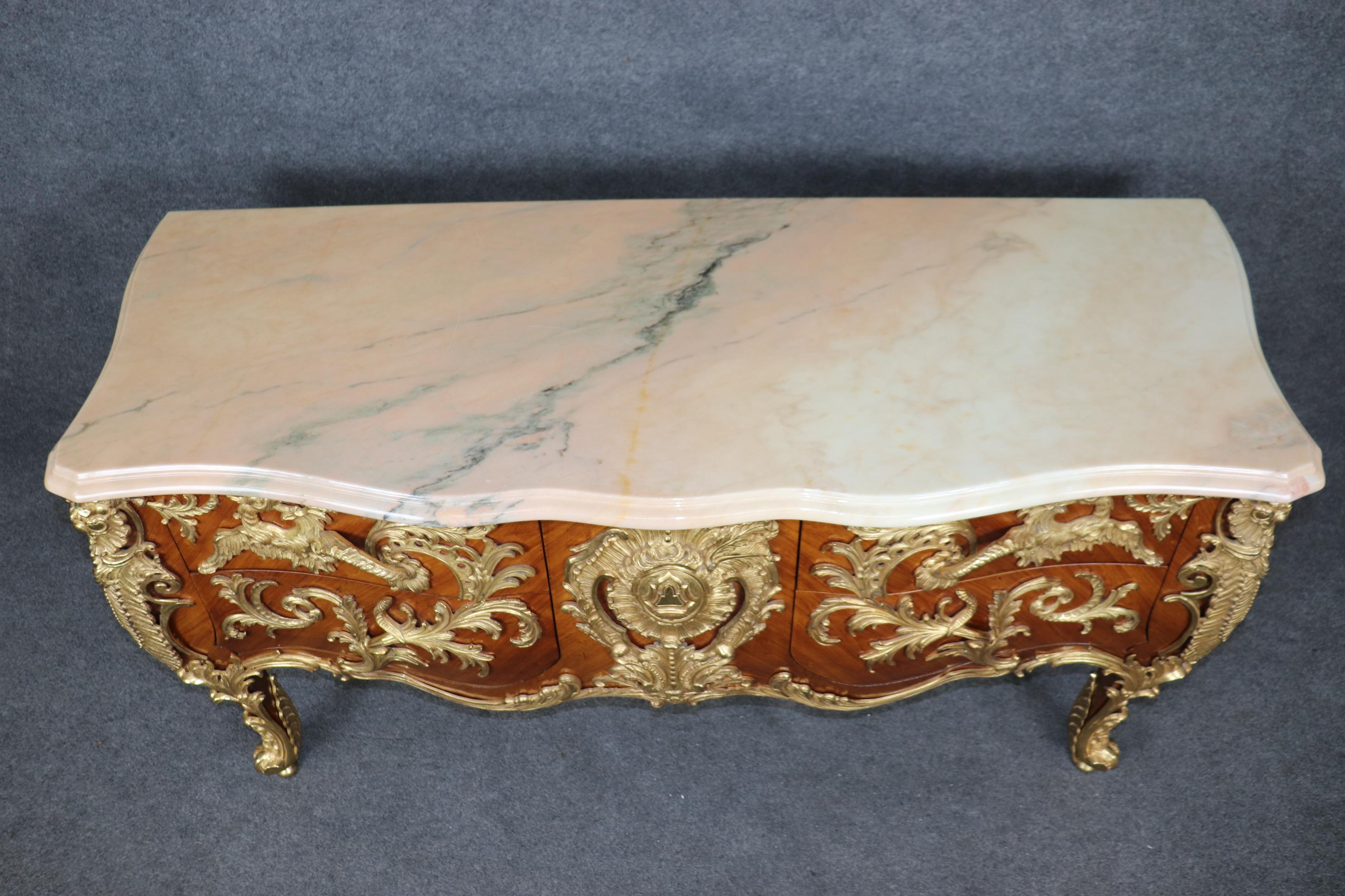 This is a gorgeous absolutely magnificent sideboard with Dore' bronze dragons and a gorgeous marble top. The kingwood case is remarkable and contrasts beautifully with the bronze mounts. The piece is in good condition with minimal signs of age and