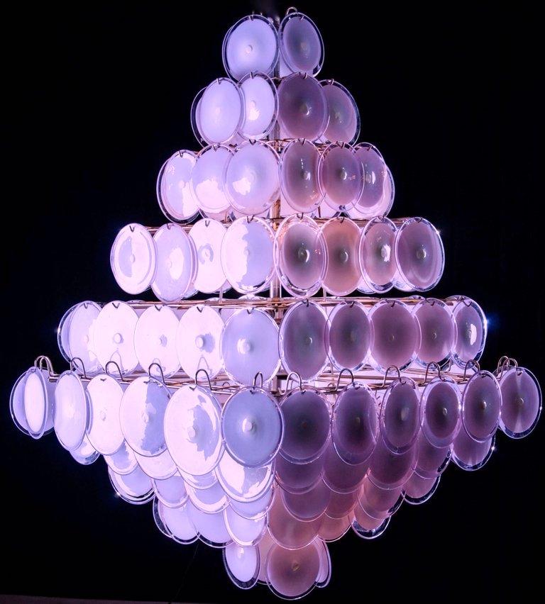 A chandelier of rare beauty and elegance. 136 Murano glass discs amethyst by Gino Vistosi, disposed in ten rows, forming two overlapping pyramids. A pair is available.

DIMENSIONS
H 55.12 in.  without chain x W 39.38 in. x D 39.38 in.
H 140 cm