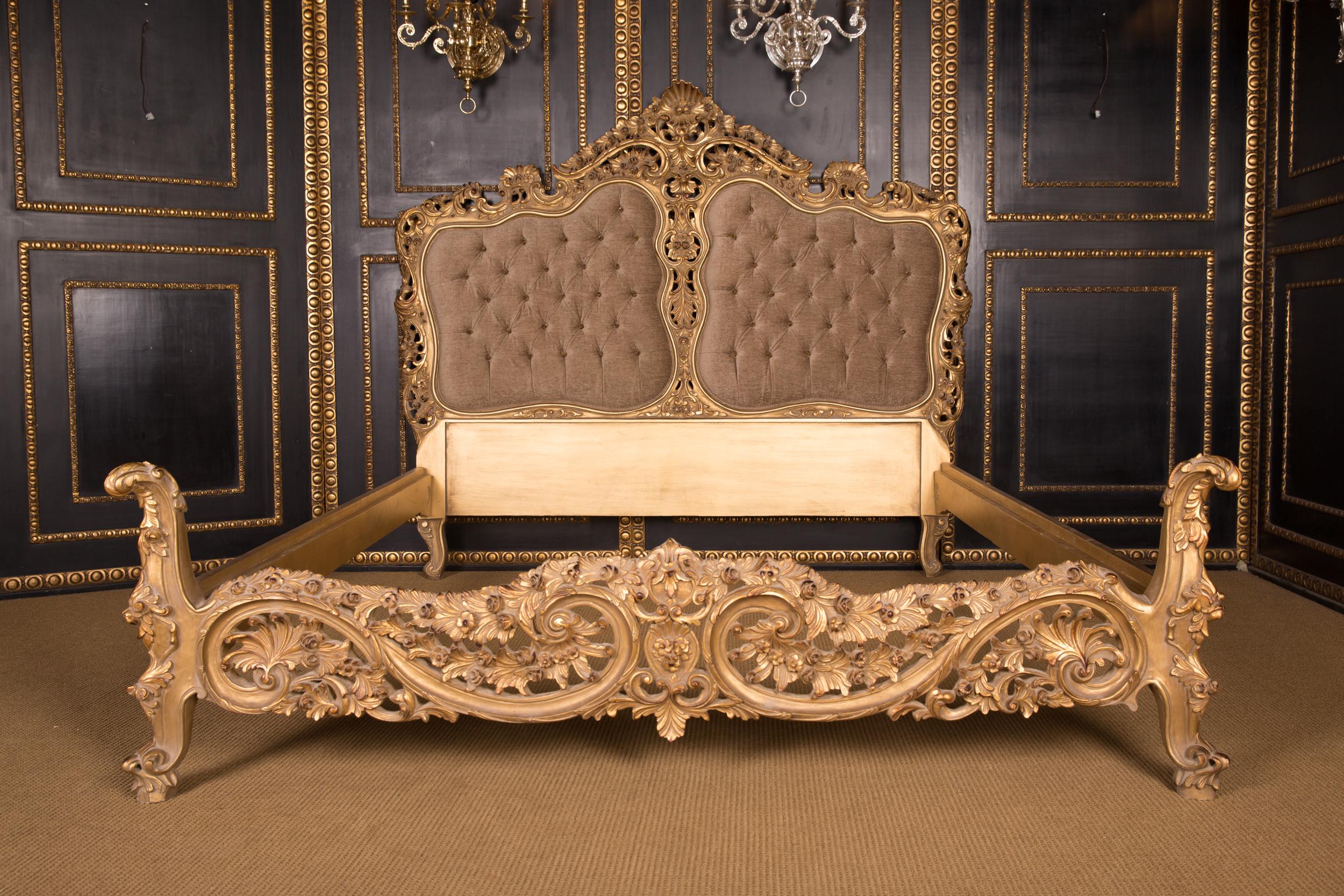 Solid beech wood, finely carved, colored and gilt gilded. Low foot and high headboard Quilted, curved backrest frame and open rocaille crowning. Everything is done by hand.