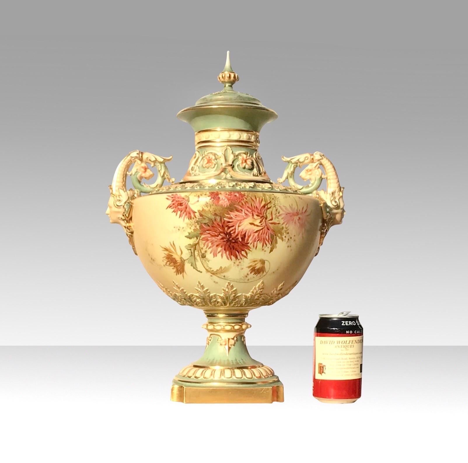 A Magnificent large Antique Royal Worcester blush ivory and turquoise porcelain vase and cover by Edward Raby.

Dated 1899
Compressed baluster, finely painted with flowers and foliage,moulded acanthus and floral decorated neck, flanked by mask