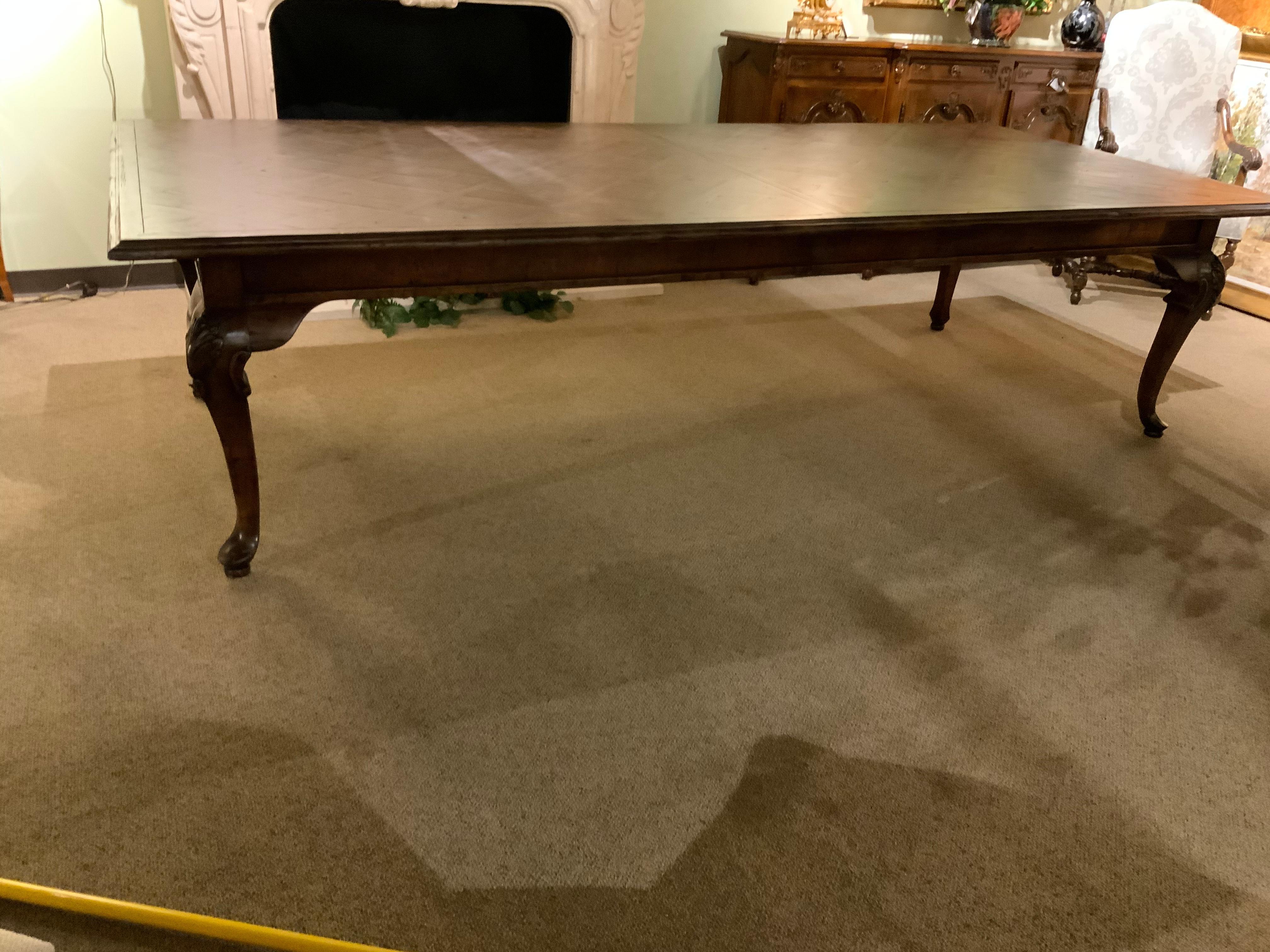 Large and table in great condition with a parquetry top. The legs are curved
With carvings on the knees. This table is 120” long with one additional leaf and measures 144”
Fully extended. The workmanship on this table is exceptional and is great for