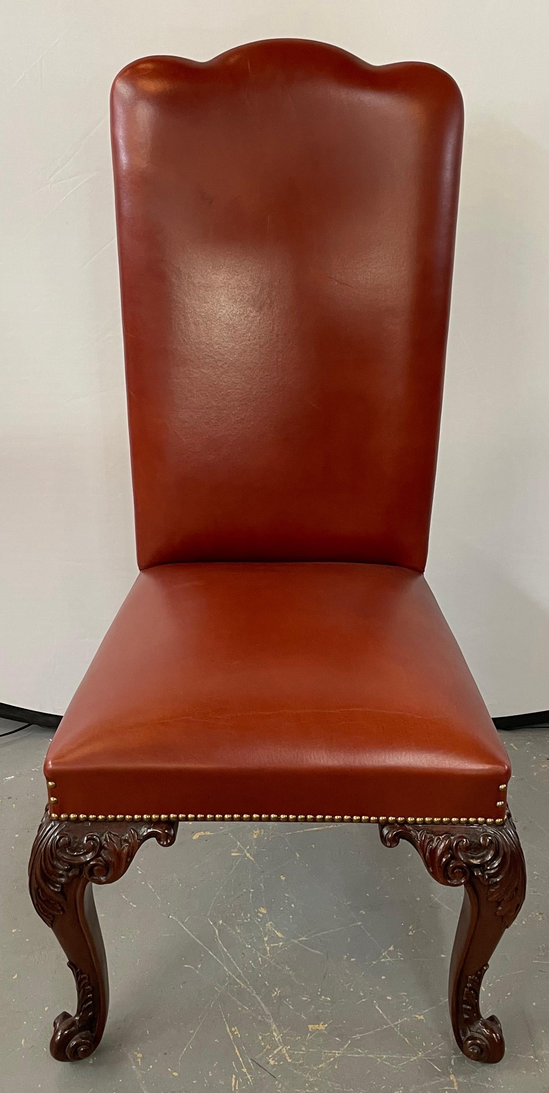An exceptional high quality custom French Louis XV genuine leather dining chairs. Featuring a brown/ Maroon classy color, the chairs are finely hand carved in a cherry mahogany and showing acanthus and floral design. Each chair is supported by four