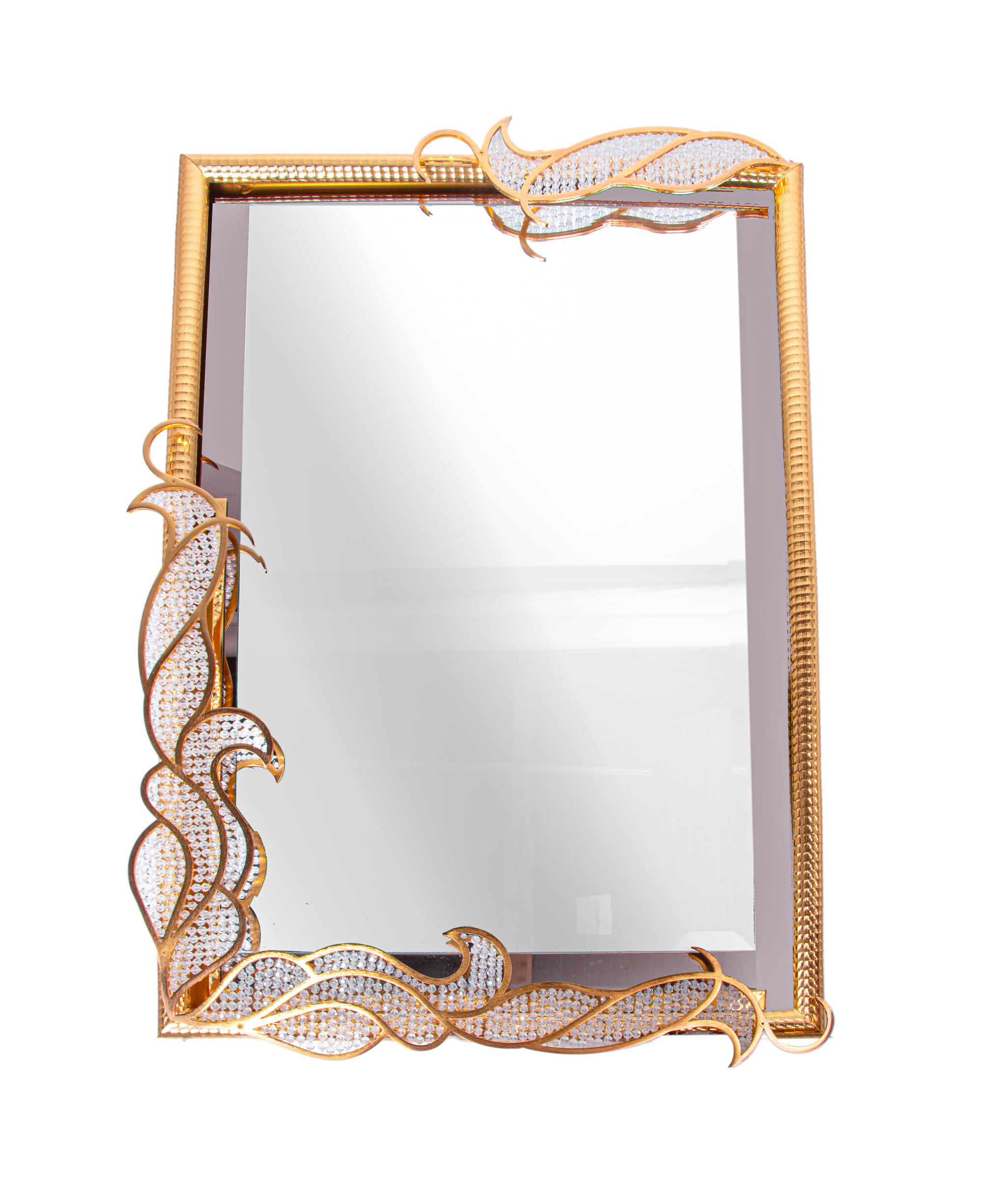 Majestic backlit mirror by Kurt Faustig with applications of Swarovski crystal elements screwing mounted on a gilded brass structure. 
 
A precious manufacturing of gold plated filigree with Swarovski crystal glass. Very heavy duty. High quality