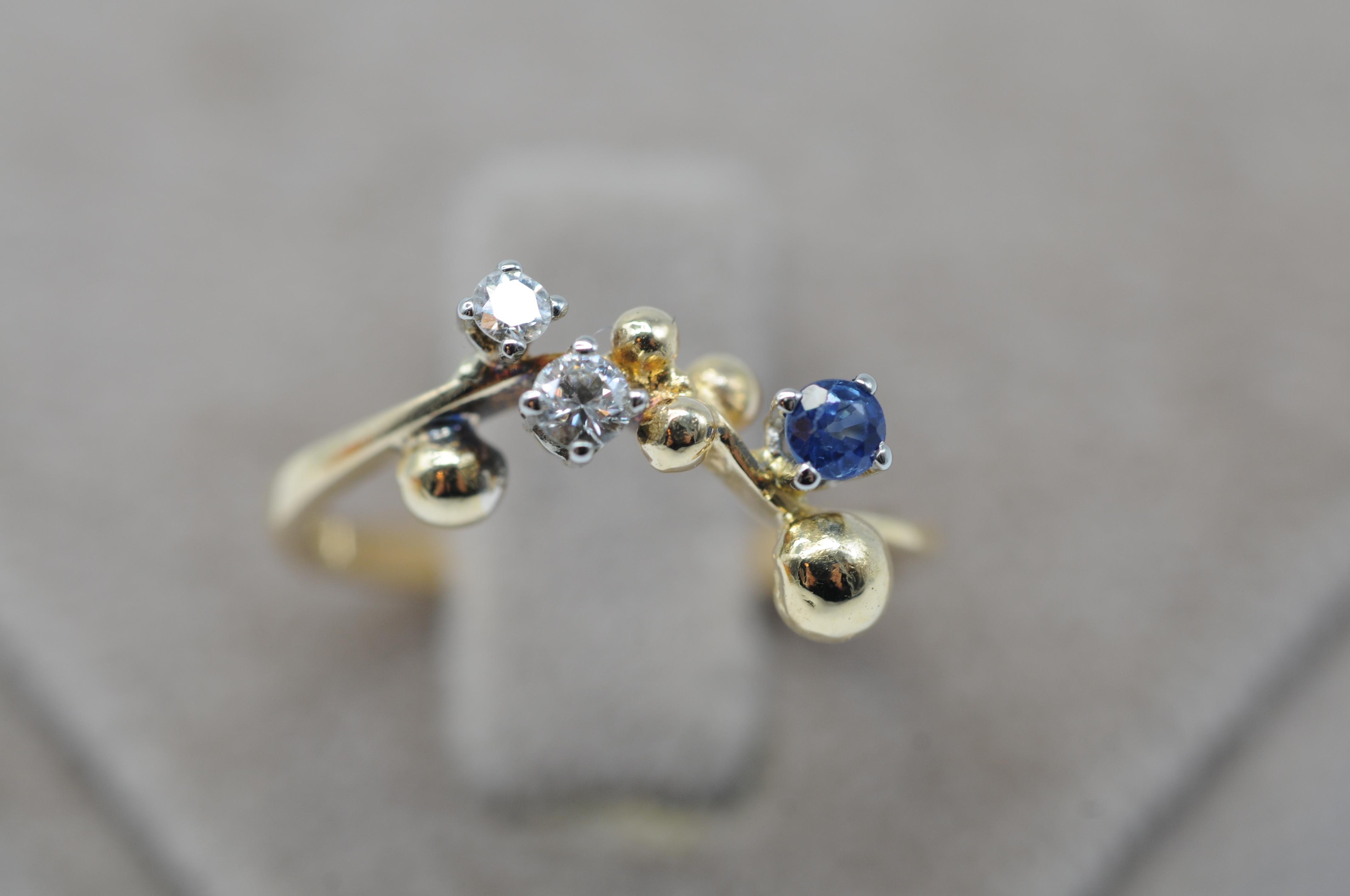 Step into a realm of unparalleled beauty with this exquisite 18k yellow gold ring, adorned with two dazzling diamonds in brilliant cuts and a captivating blue sapphire, all masterfully crafted by the esteemed German goldsmith, Master Wurzbacher.

As