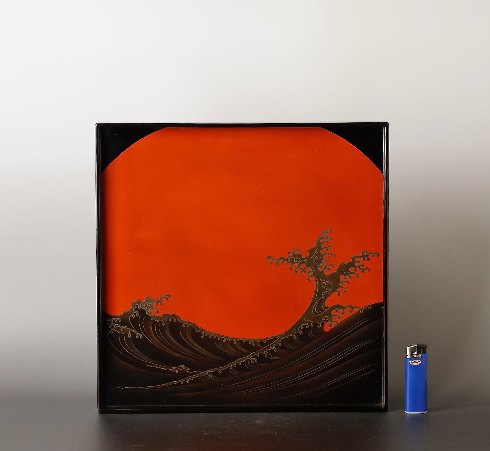 The Japanese lacquered tray features an exceptionally rendered Great Wave and Rising Sun design, encapsulating the dynamic and powerful elements of nature. Originating from the Edo-Meiji period in the late 18th to early 19th century, this tray is an