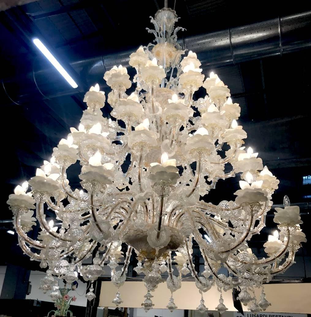 Amazing Murano chandelier: 64 arms!!! Five floors of lights and a multitude of flowers in glass paste and gold inclusion.
An authentic masterpiece out of the historic Murano furnaces.