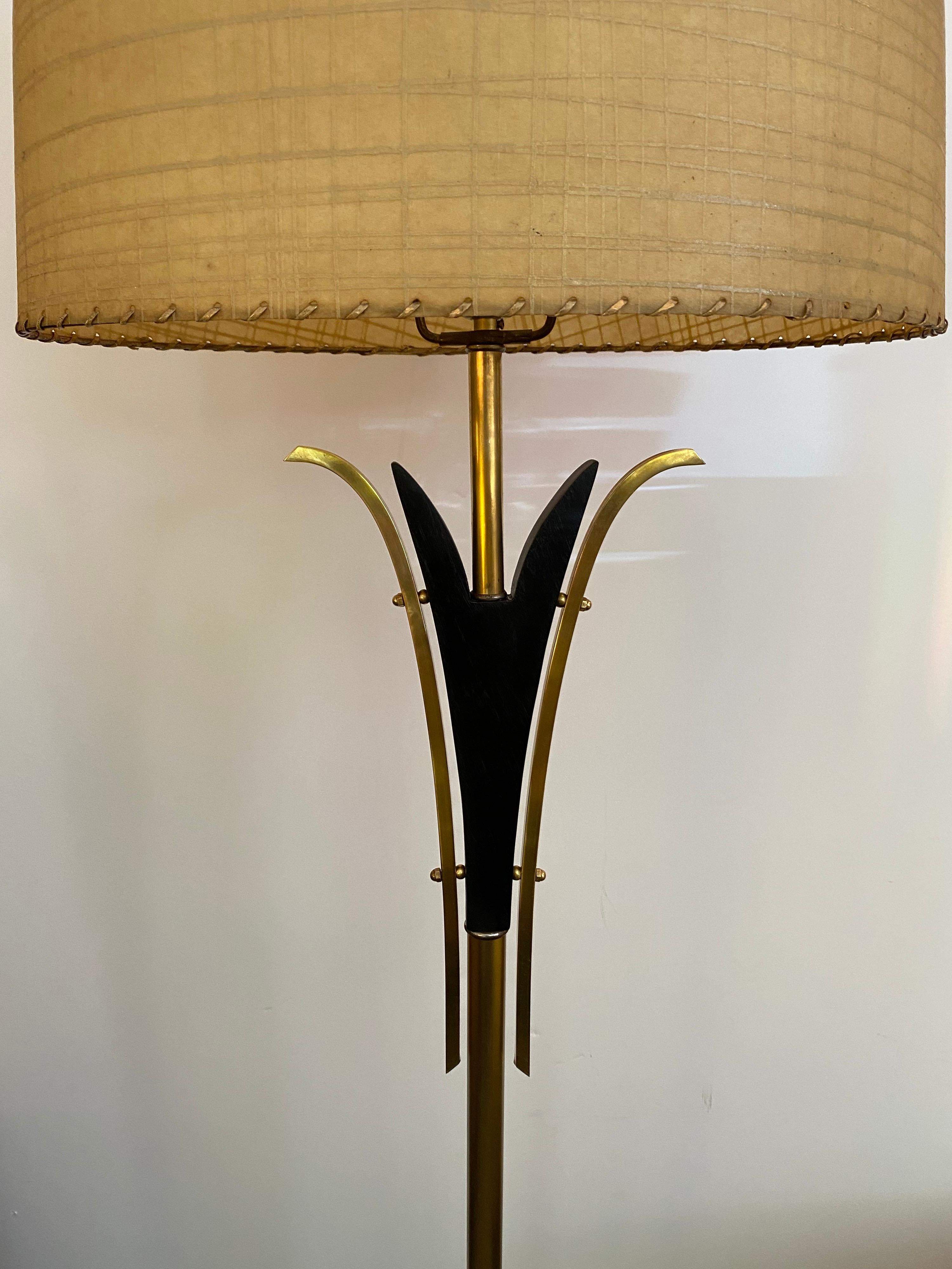 Majestic lamp company floor lamp. Brass has been cleaned and black parts repainted. Lamp has been rewired. Classic mid 50's lamp with fiberglass lampshade. Black base is 9.5 square. Very unusual tall brass finale with ball top!