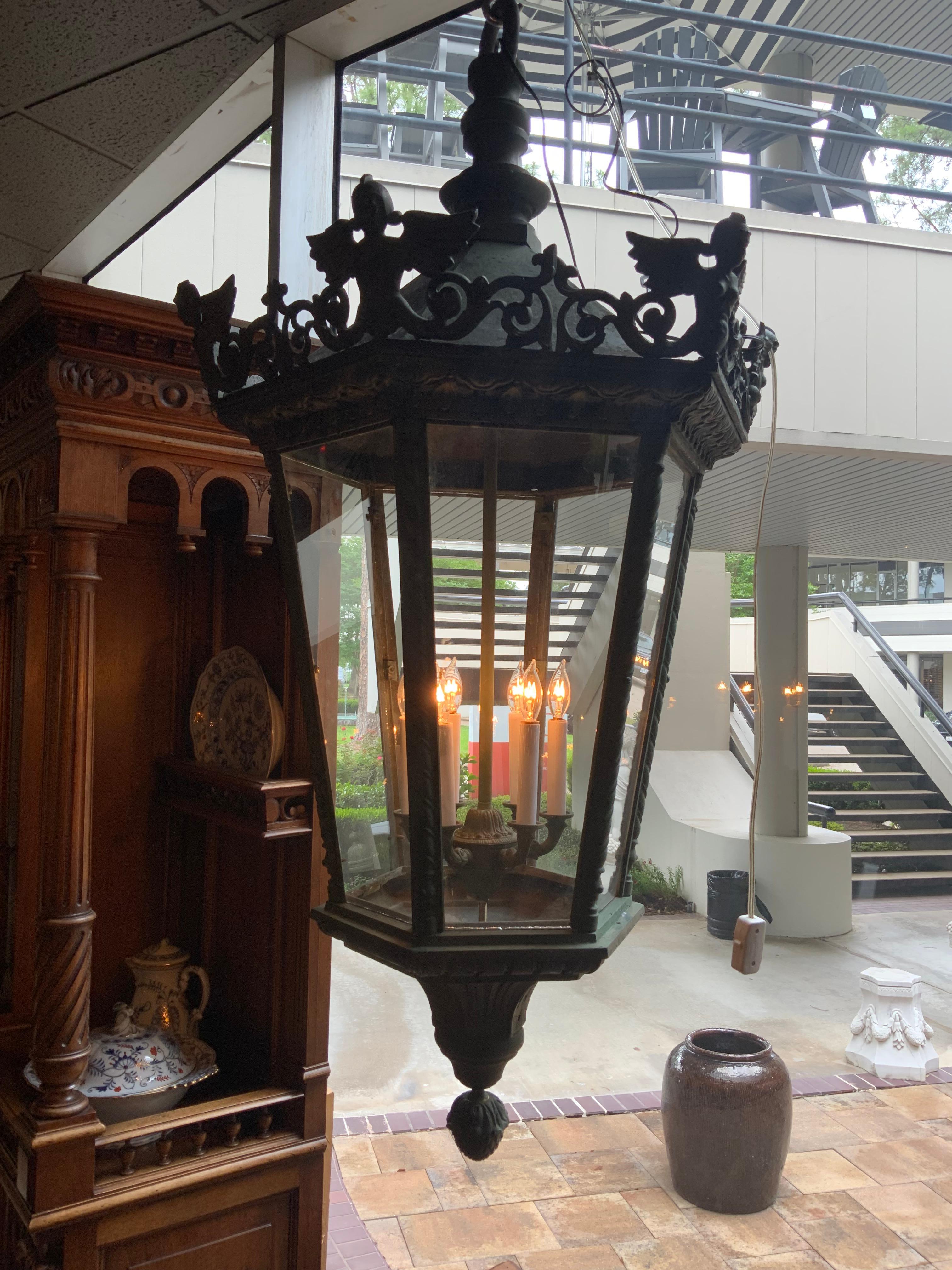 This piece is great for outdoor use or interior. It has five
Glass panels that surround 6 lights on the interior.
Wiring is good. Figural winged maidens ate at the
Upper edge. The fixture ends in an acorn finials.
It comes with a matching canopy.