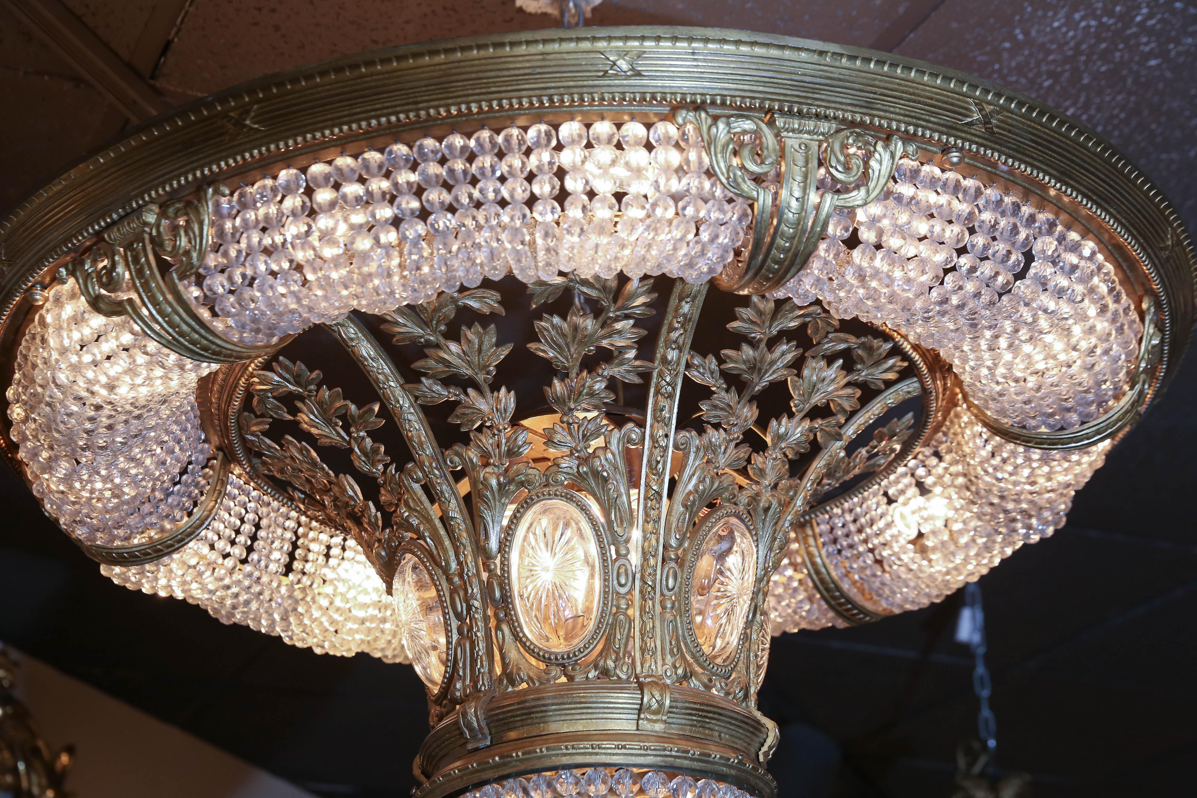 Cast bronze frame with European crystal beads and etched
Oval glass inserts. Early 20th century. Mounts flush with the ceiling.
 