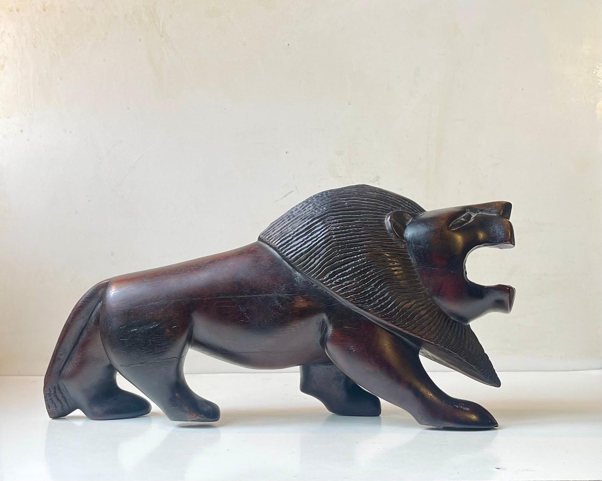 Hand-Carved Majestic Lion Sculpture in Carved Dark Hardwood For Sale