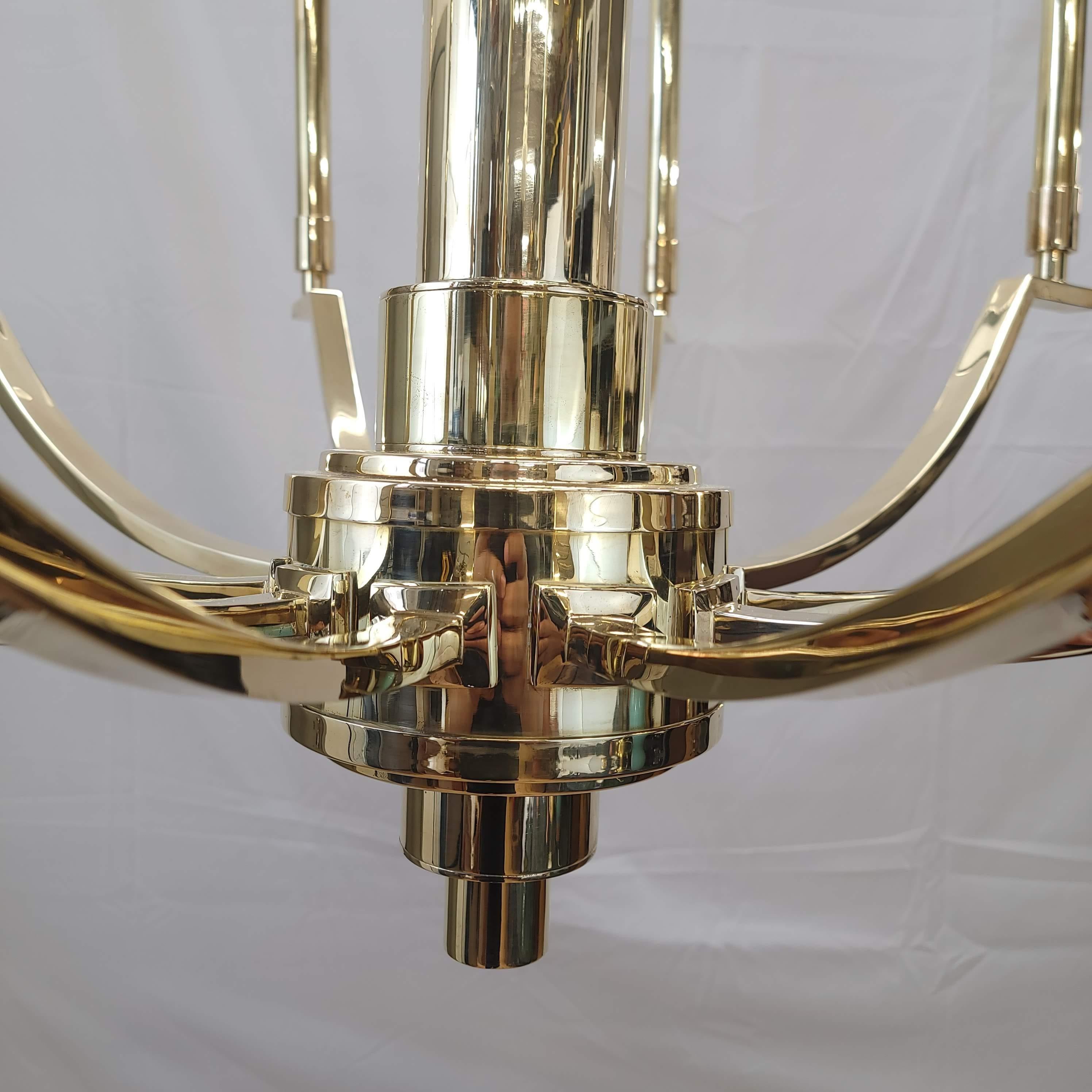 Elevate your space with our Majestic Mid-Century Modern Chandelier. Exuding sophistication, this piece features a radiant polished brass finish that brings a touch of glamour to any room. The streamlined design boasts ten slender arms, each
