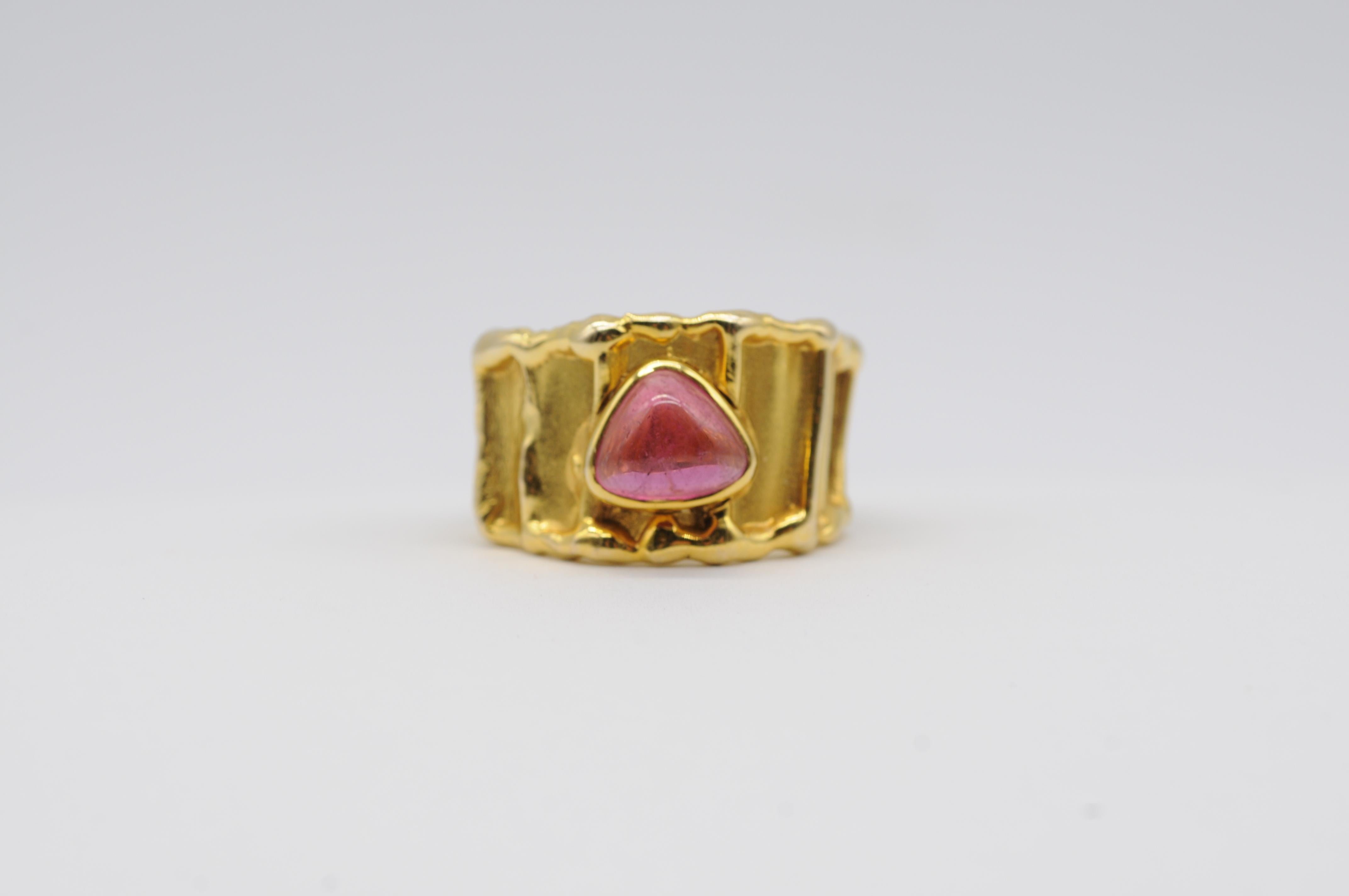 Immerse yourself in the captivating allure of this exquisite red tourmaline ring, embraced by an intricate 14k yellow gold setting that exudes elegance and refinement. This stunning ring epitomizes everything that defines aesthetic beauty and